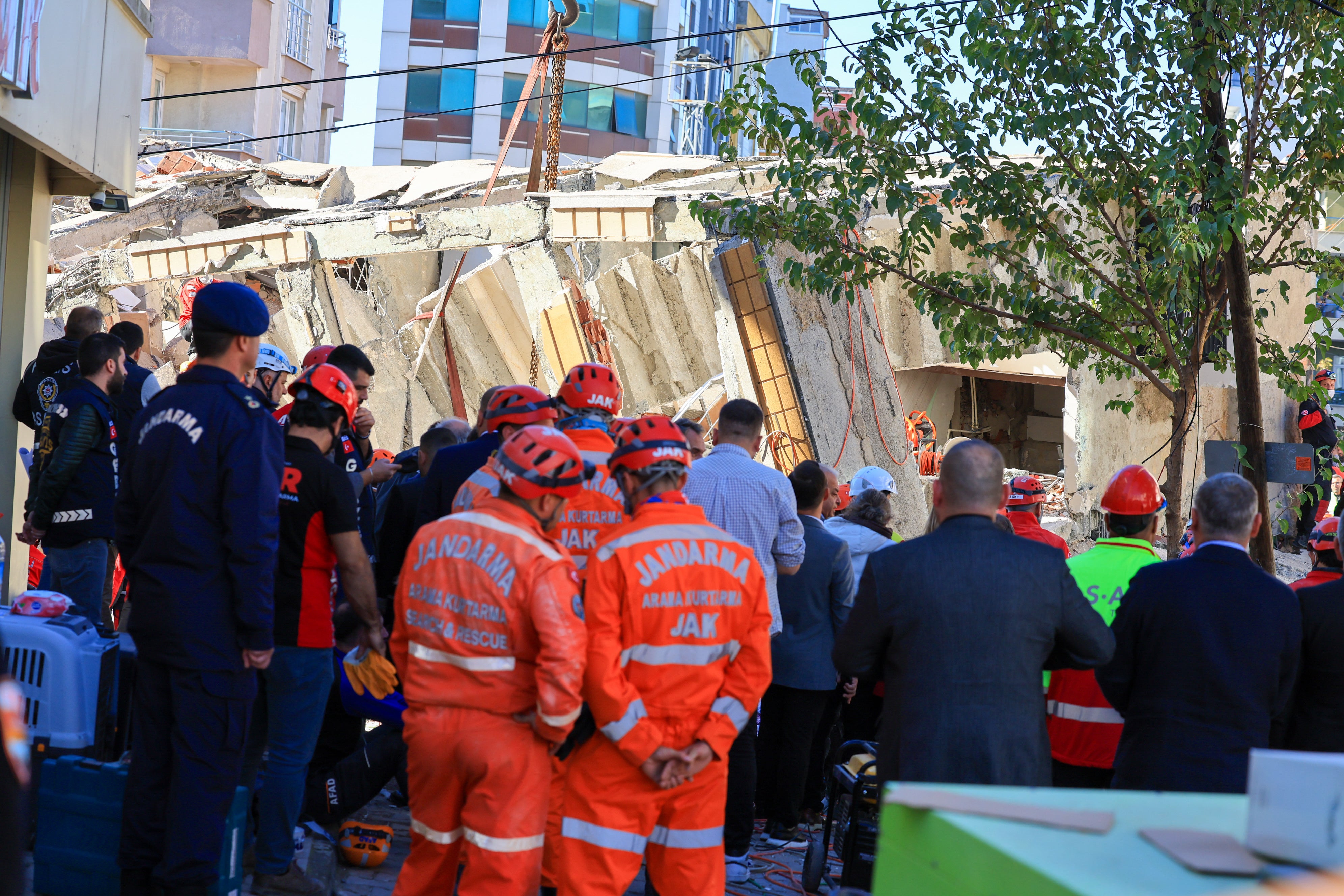 Firefighters and emergency rescue teams search for trapped people after a residential building collapsed in Gebze, Turkey