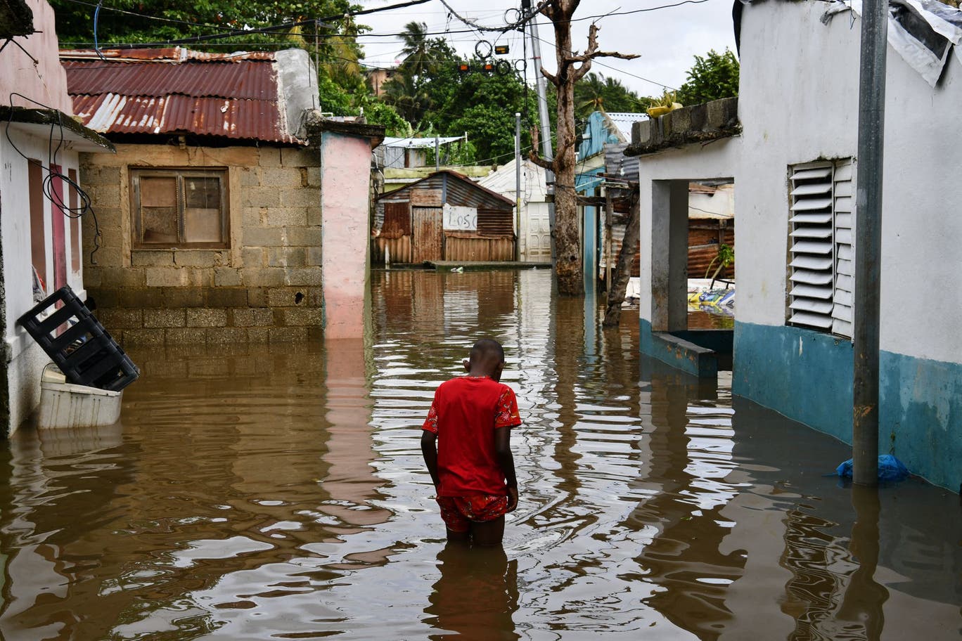 A man walks through floodwaters in Jamaica