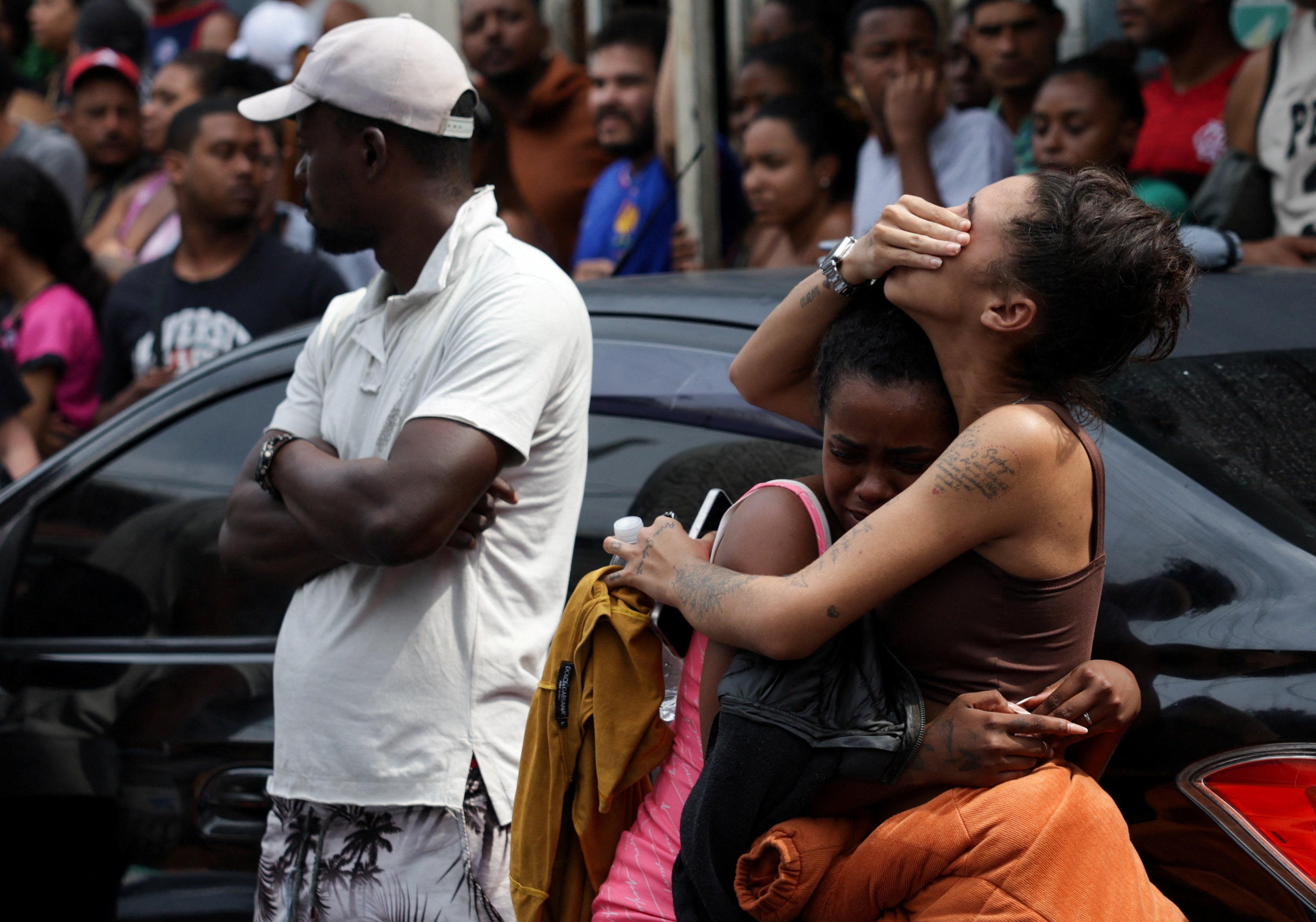 Mourners react as people gather around bodies, the day after a deadly police operation against drug trafficking at the favela do Penha, in Rio de Janeiro, Brazil.