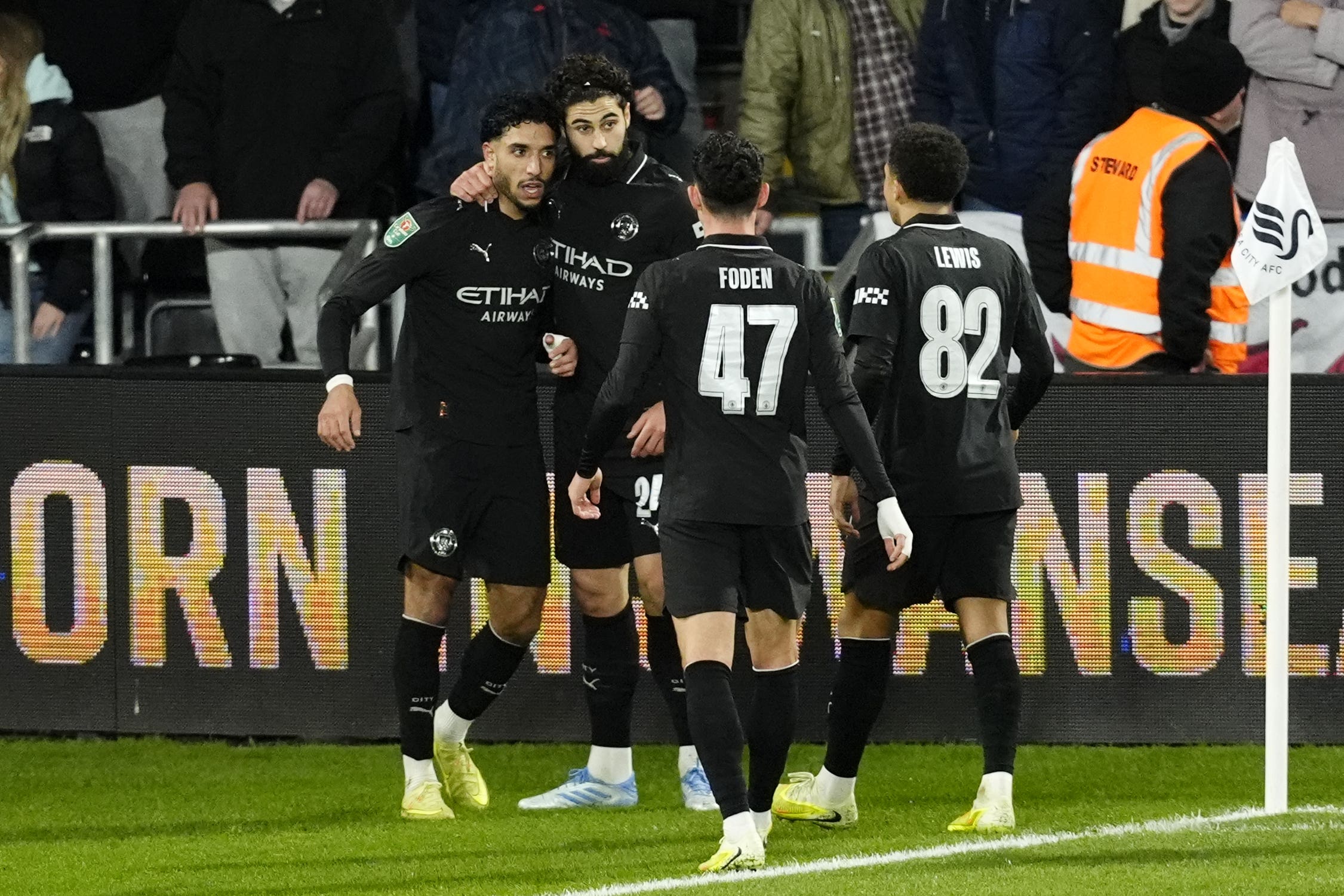 Manchester City’s Omar Marmoush (left) celebrates with team-mates after scoring his side’s second goal at Swansea