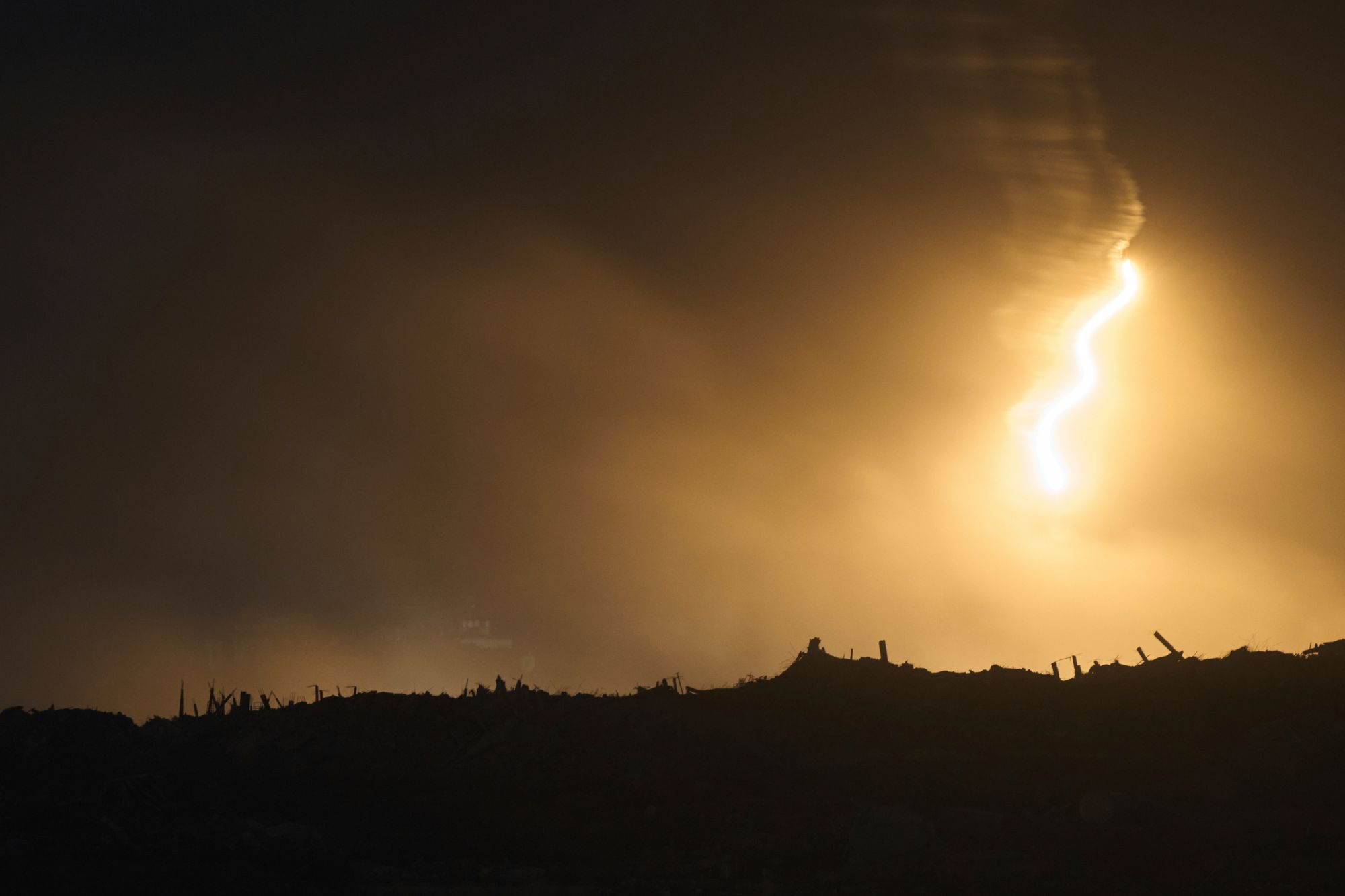 An Israeli army flare drifts over an area in the northern Gaza Strip on Tuesday