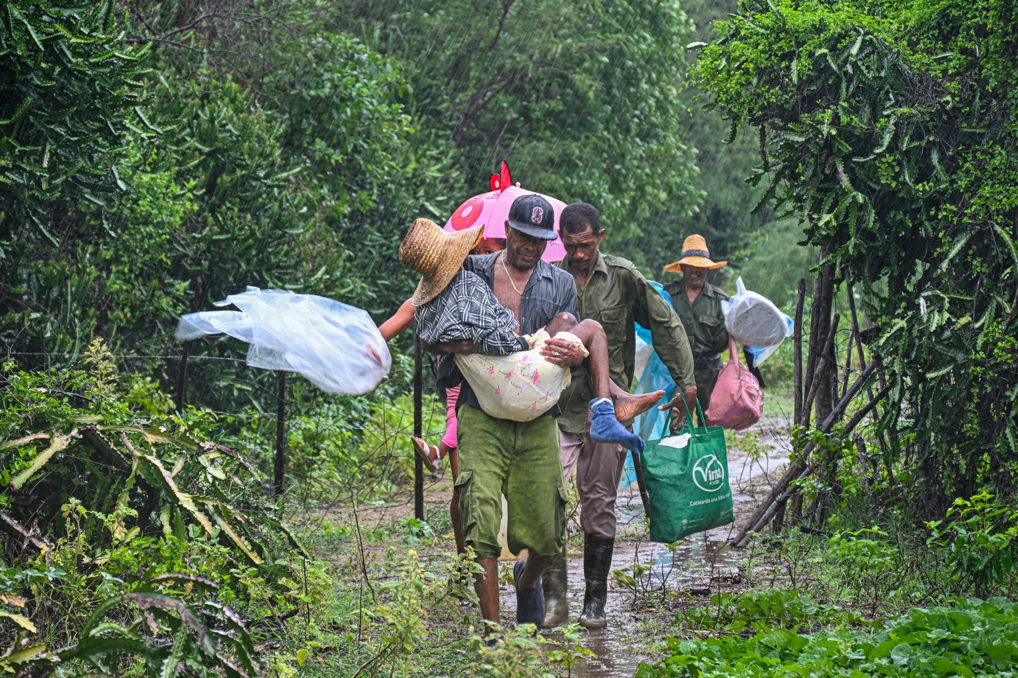 Residents self-evacuate under pouring rain from Playa Siboney to safe locations ahead of the arrival of Hurricane Melissa, in Santiago de Cuba, Cuba