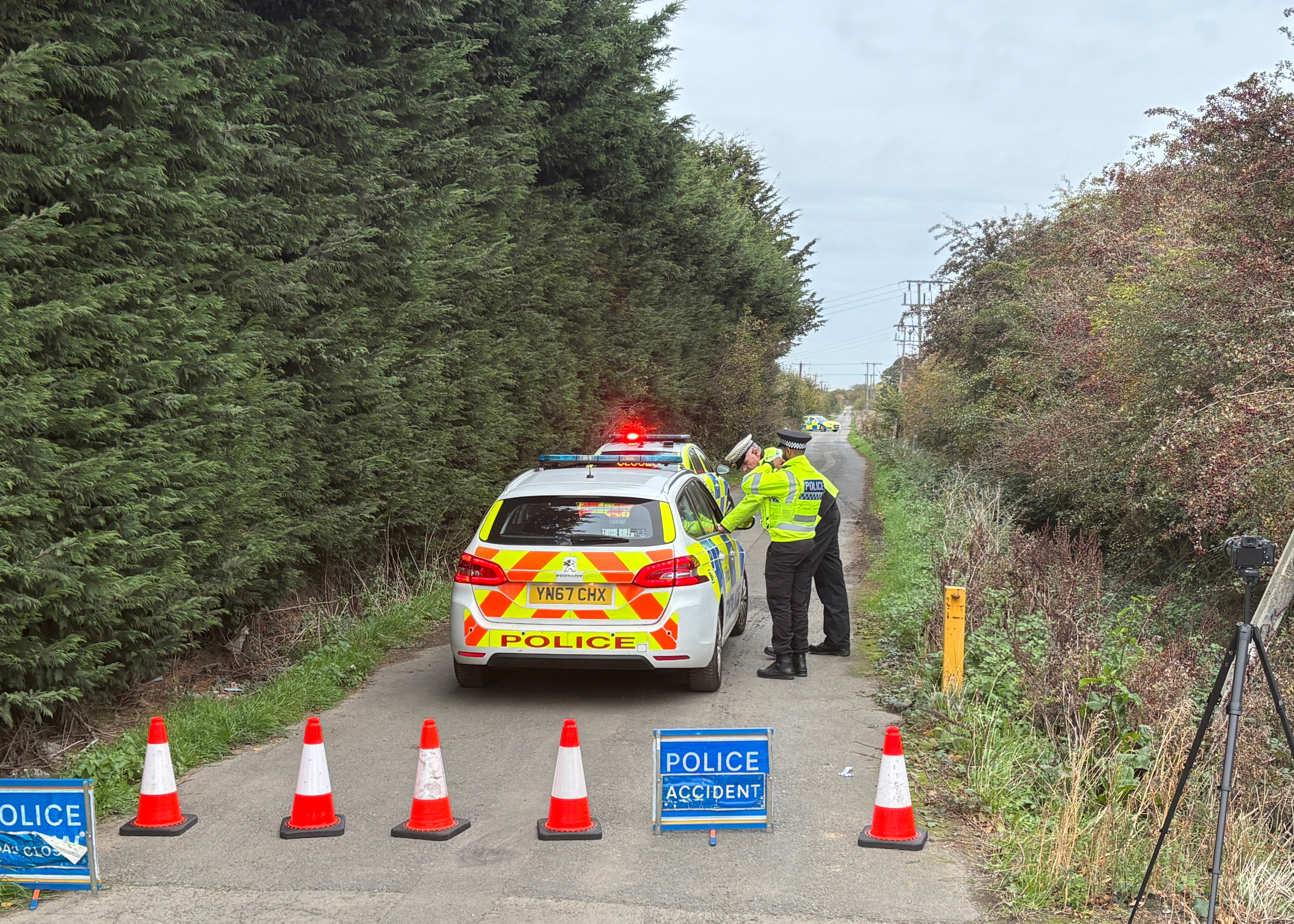 Police officers man the cordon near the site of the helicopter crash