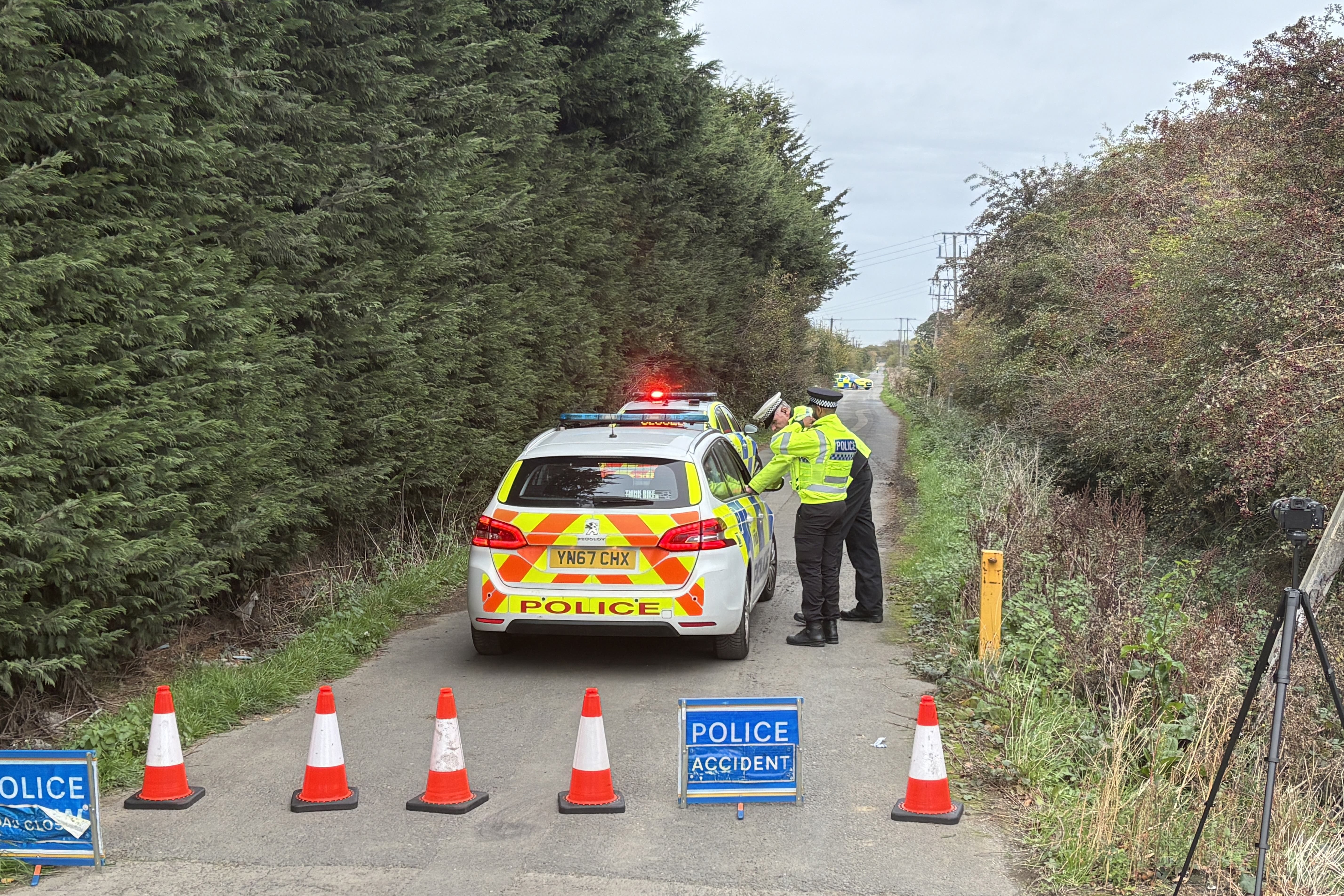 Police officers man the cordon near the site of a helicopter crash (Dave Higgens/PA)