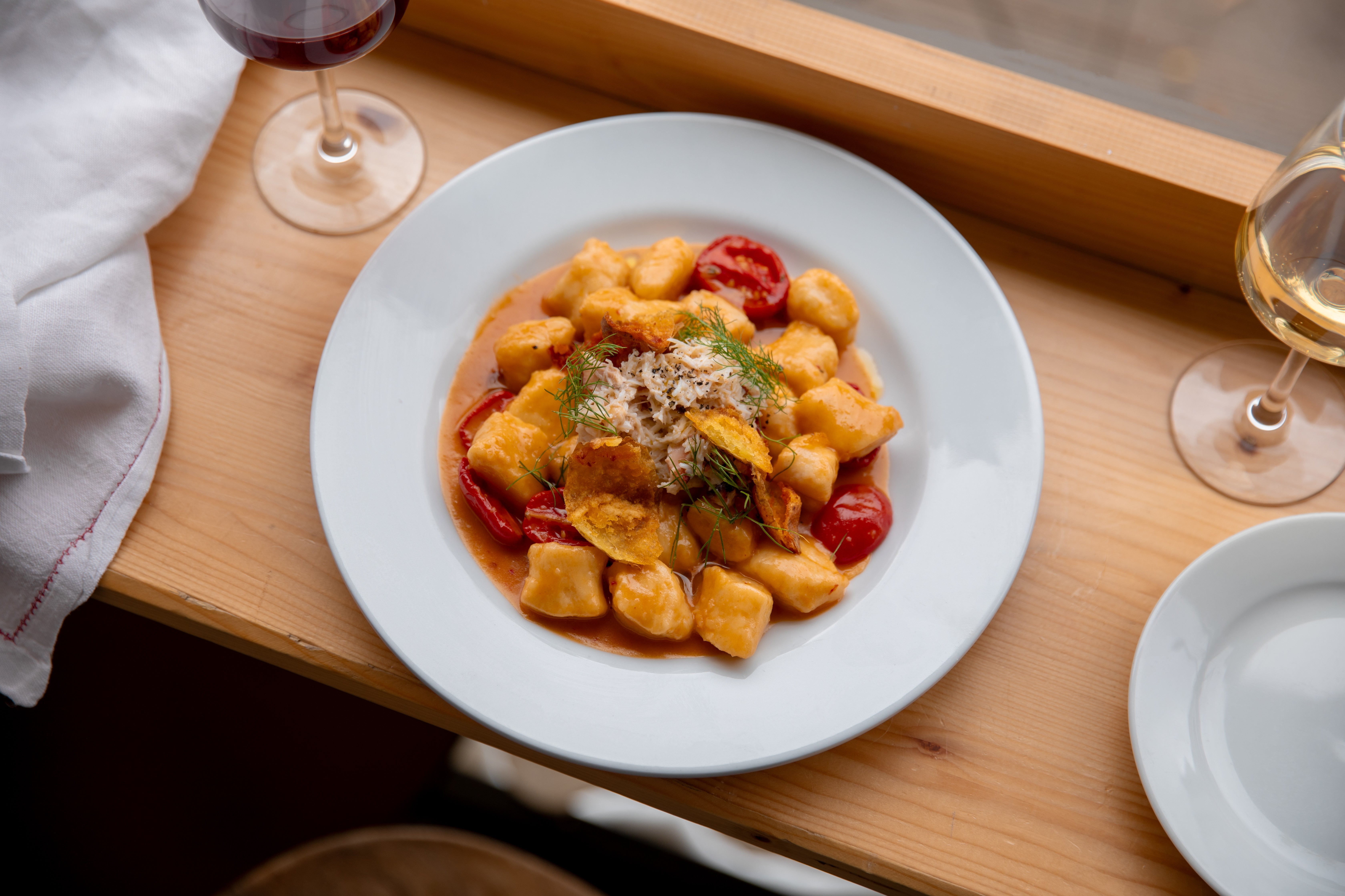 A chef’s memory in a bowl – pillowy gnocchi meets shellfish bisque and sweet roasted tomatoes