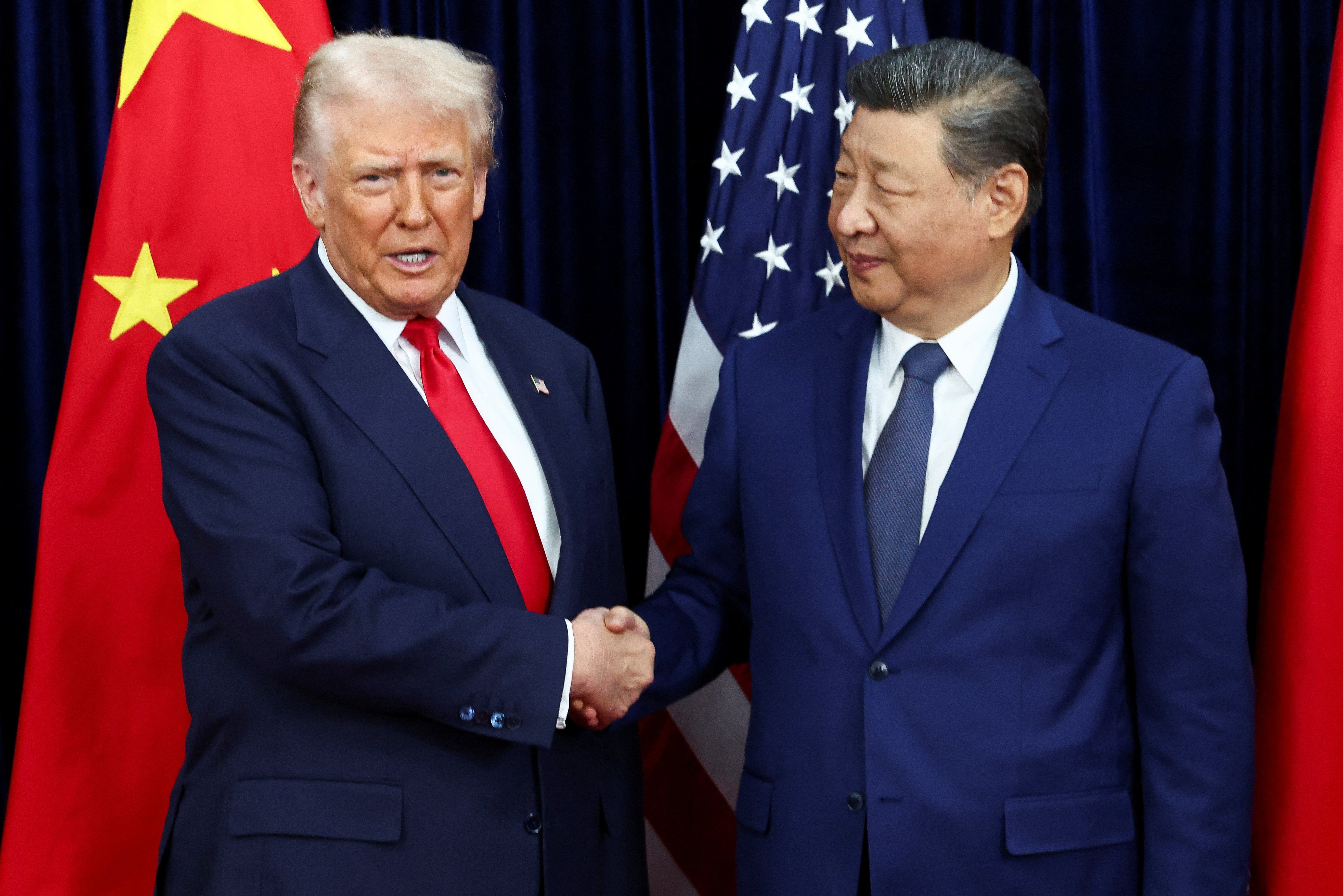 Trump and Xi pose for reporters before their summit meeting in South Korea
