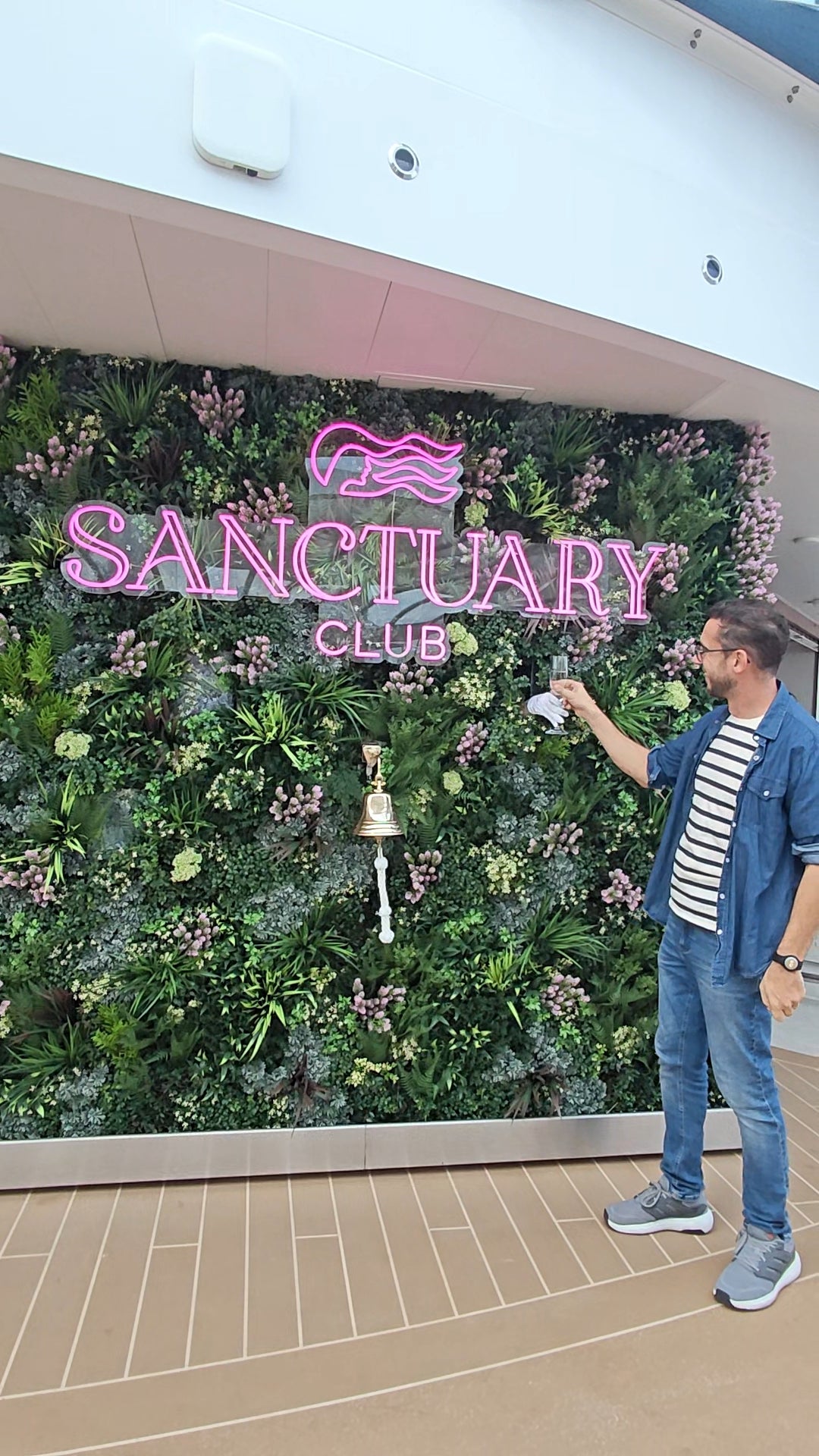Marc Shoffman receives a glass of champagne from behind a wall in The Sanctuary