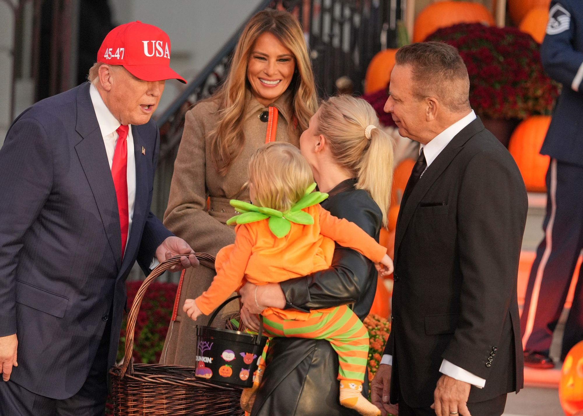 President Donald Trump greets White House Press Secretary Karoline Leavitt and her family at the White House Halloween event