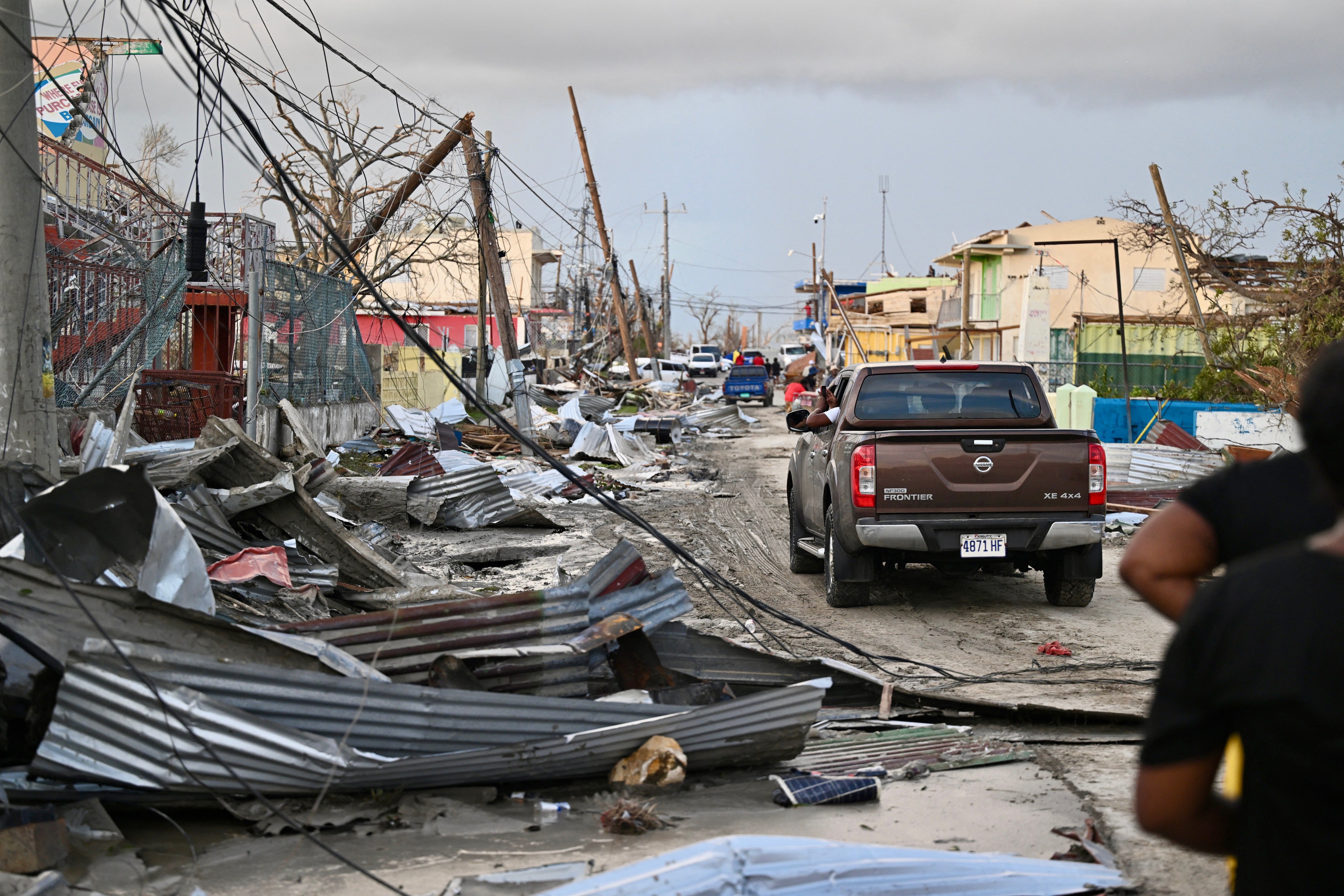 A car drives through the a destroyed neighborood following the passage of Hurricane Melissa, in Black River, Jamaica