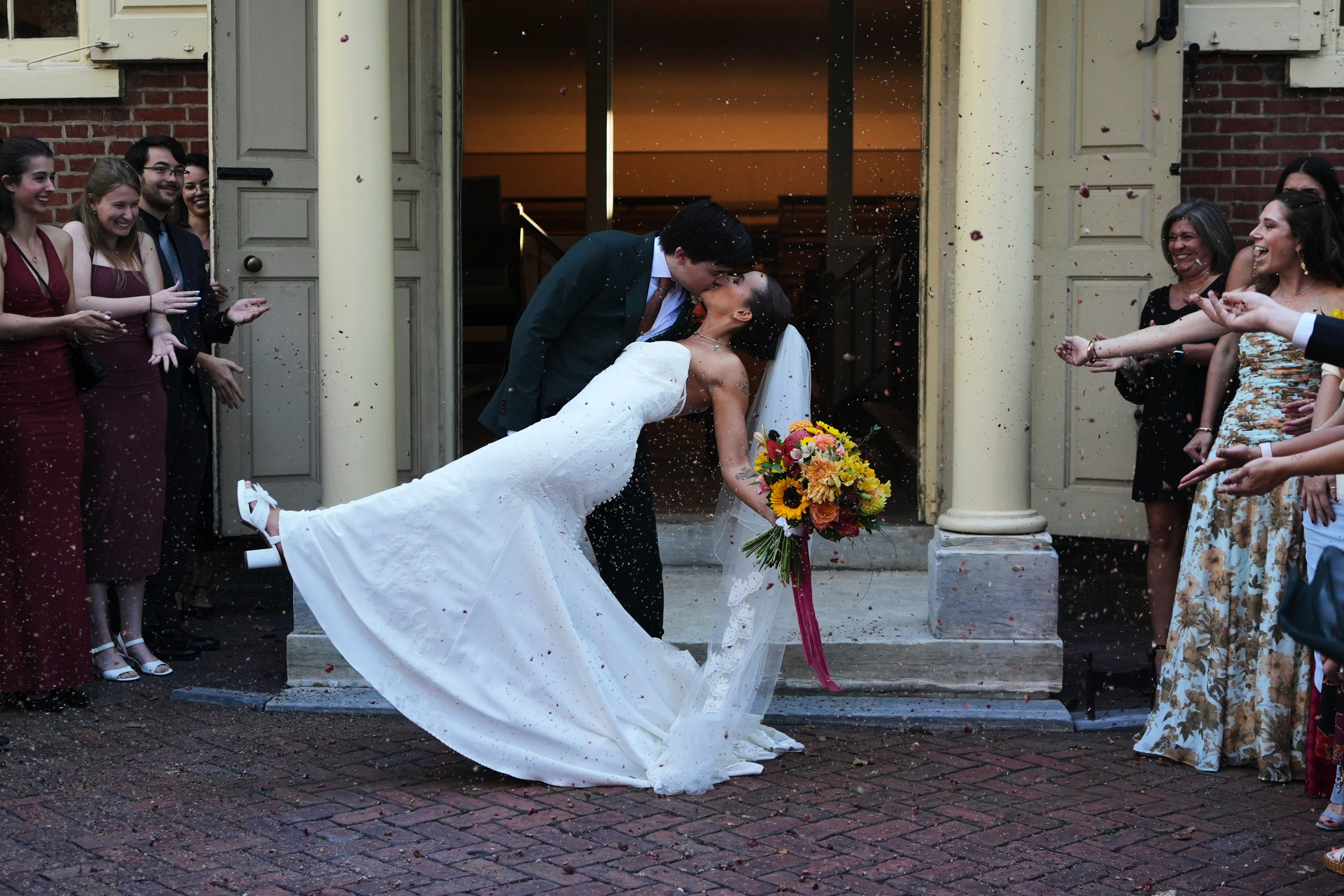 Benjamin Barger and Emily Philbrook kiss as they walk out of Arch Street Meeting House after their traditional Quaker wedding in Old City Philadelphia on Oct. 3, 2025. (AP Photo/Luis Andres Henao)
