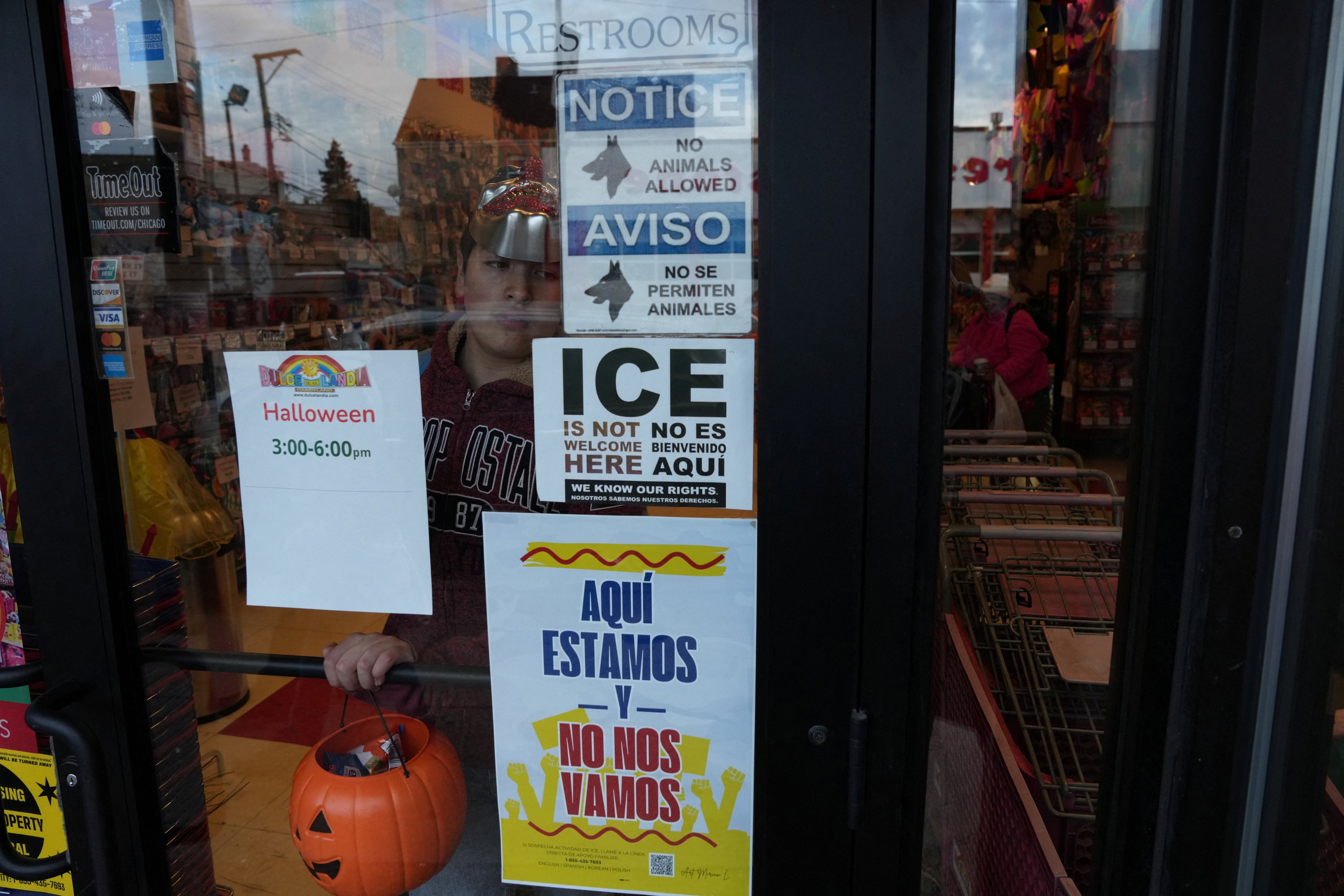 Anti-ICE signs are displayed in a shop in Chicago