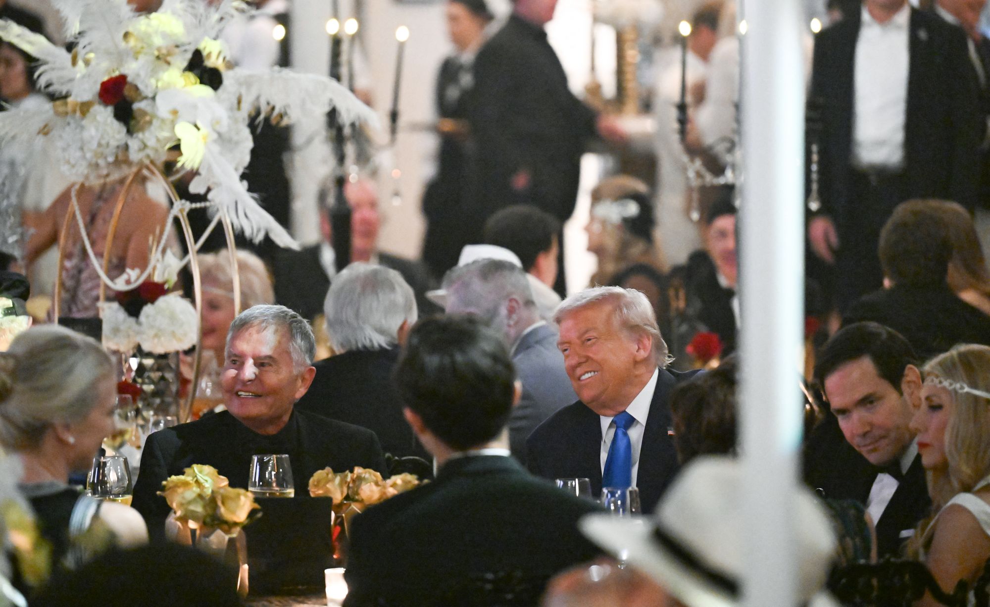 President Donald Trump, sat beside Secretary of State Marco Rubio, enjoys his lavish Halloween party at Mar-a-Lago on Friday night