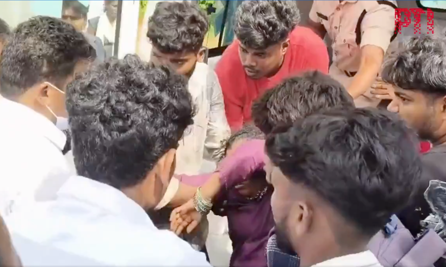 <p>A woman is helped to safety following the surge at the Swamy Venkateswara Temple in Andhra Pradesh’s Srikakulam</p>