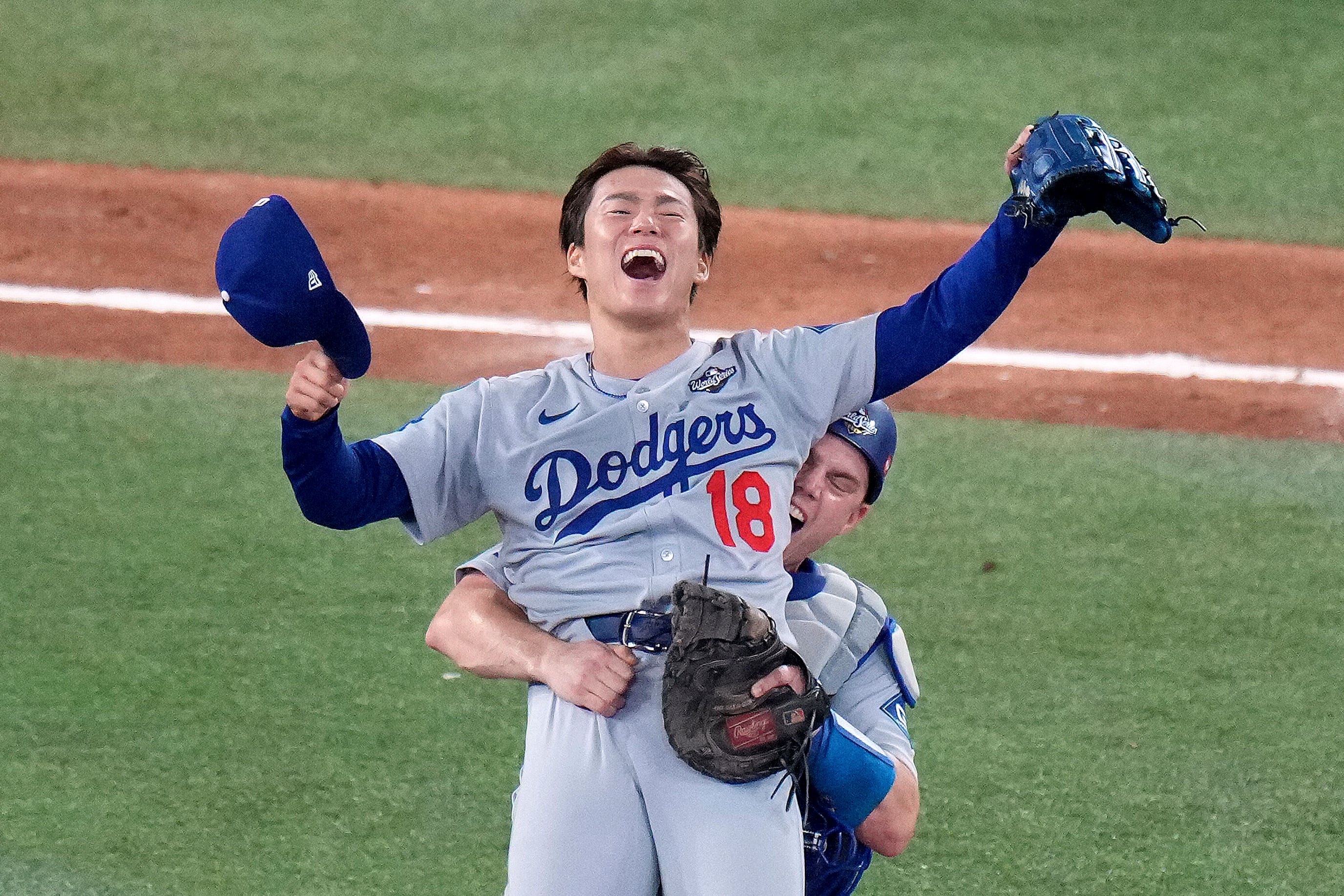 Los Angeles Dodgers’ Will Smith, right, celebrates with Yoshinobu Yamamoto (18) after the team defeated the Toronto Blue Jays in Game 7 of baseball’s World Series (Chris Young/The Canadian Press via AP)