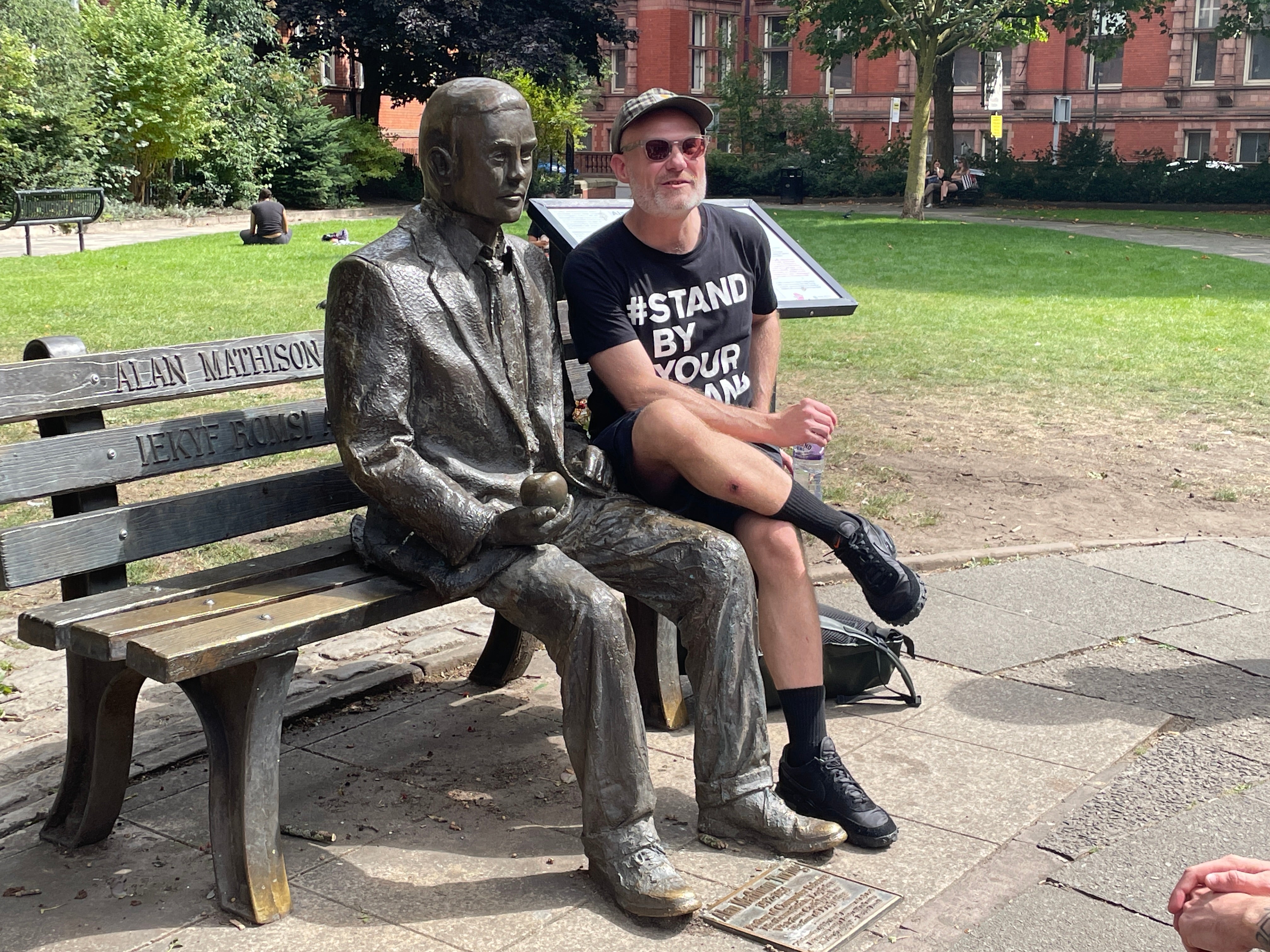 Guide Chris Hoyle sitting next to Alan Turing statue in Sackville Gardens