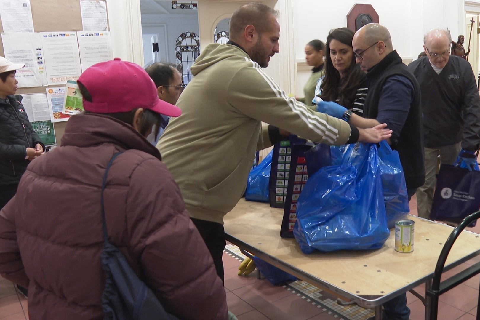 Volunteers at a food pantry passing out food