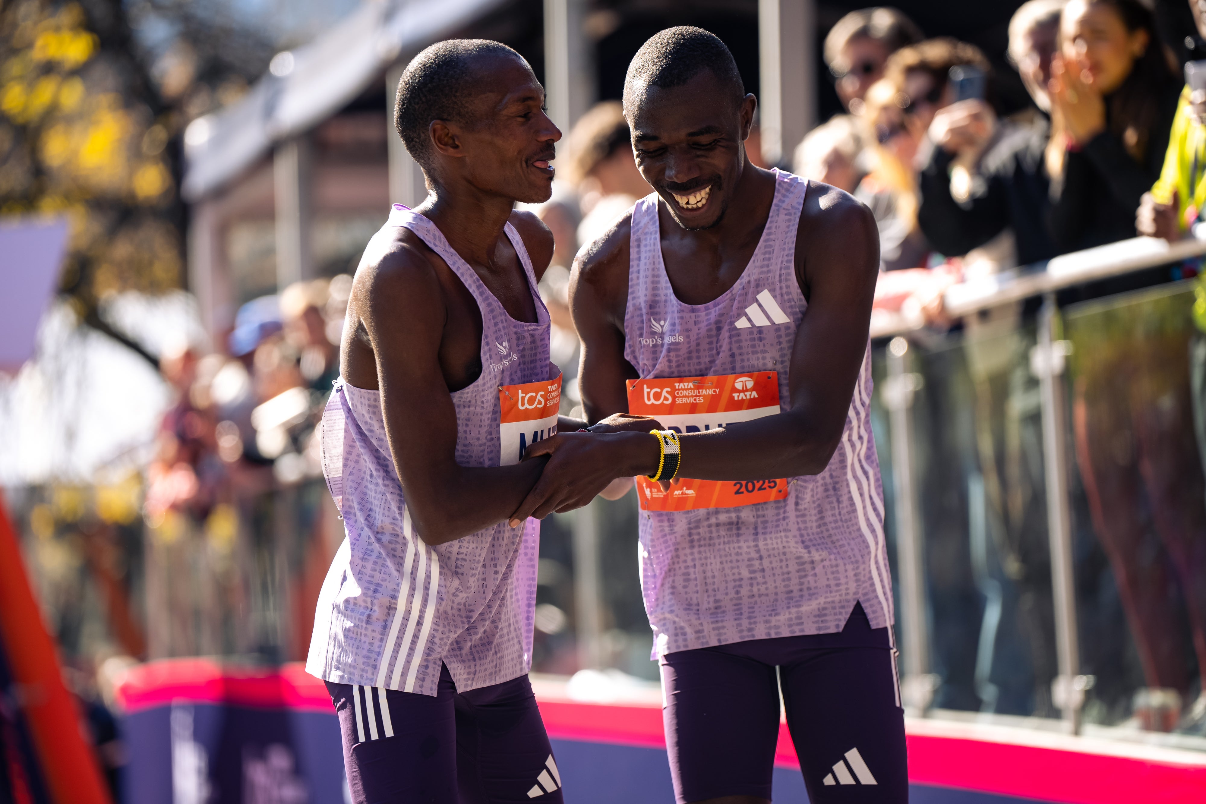 Alexander Mutiso and Benson Kipruto laugh with each other after a close finish