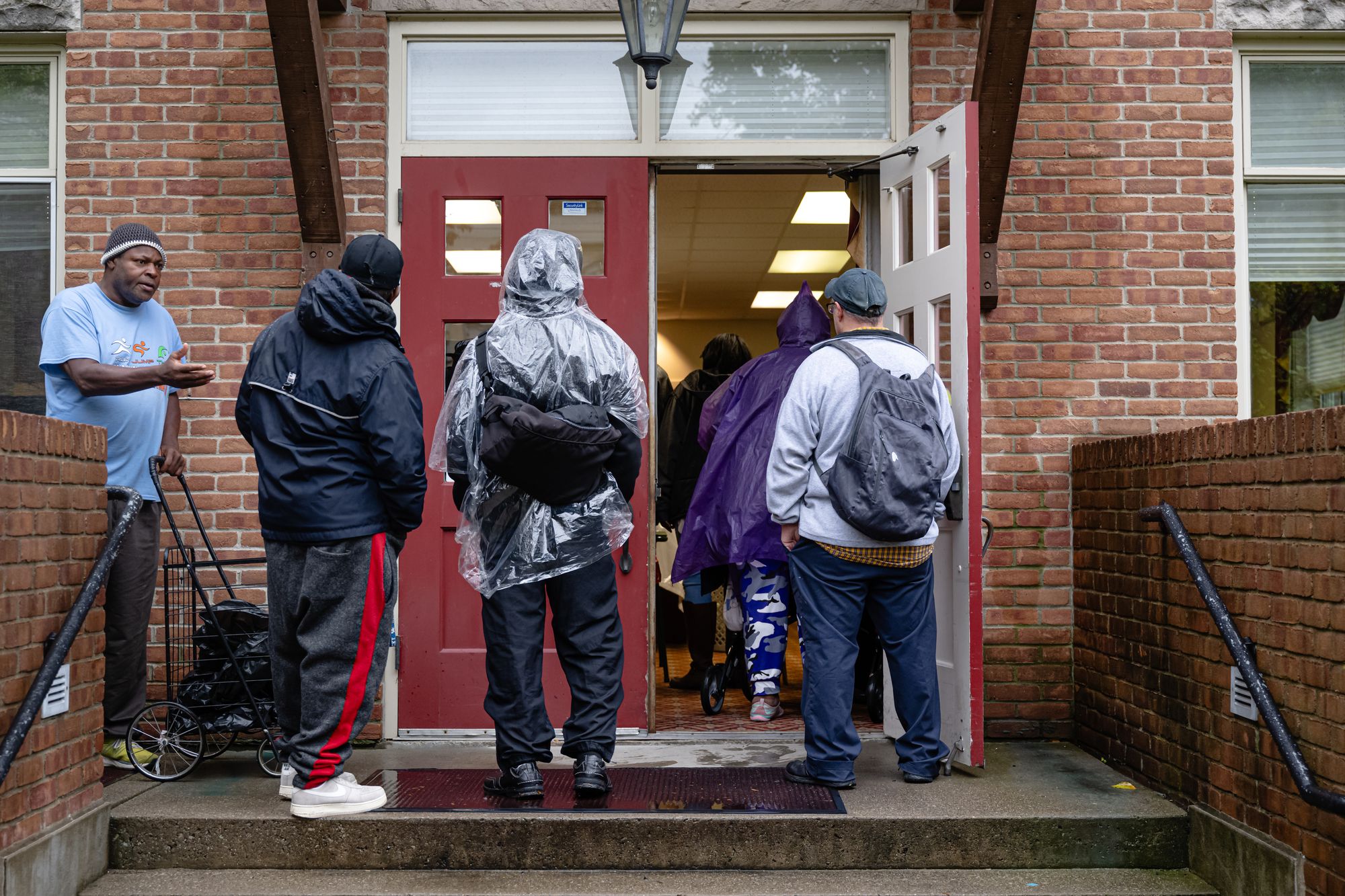 Community members wait in line to enter the food pantry service at Calvary Episcopal Church on Oct. 30, 2025, in Louisville, Ky
