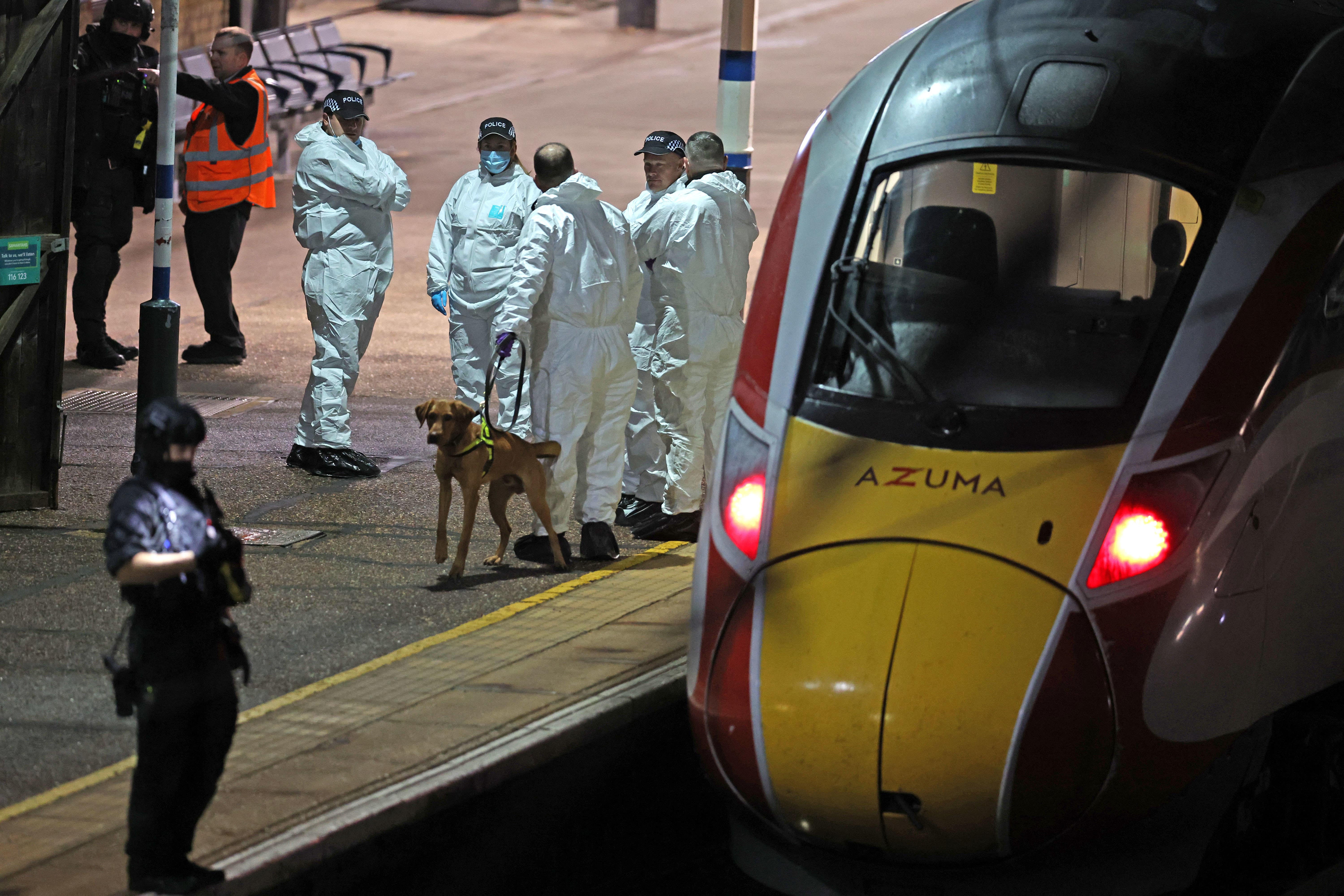 Police on the platform by the train at Huntingdon station in Cambridgeshire after a number of people were stabbed (Chris Radburn/PA)