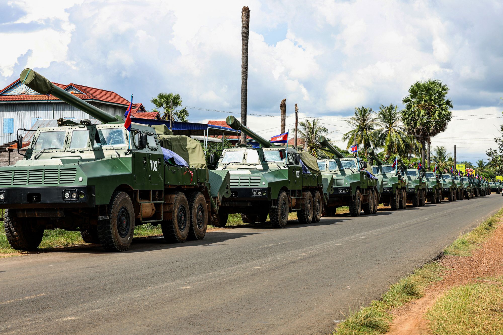 A convoy of howitzers moves along a street in Preah Vihear province of Cambodia