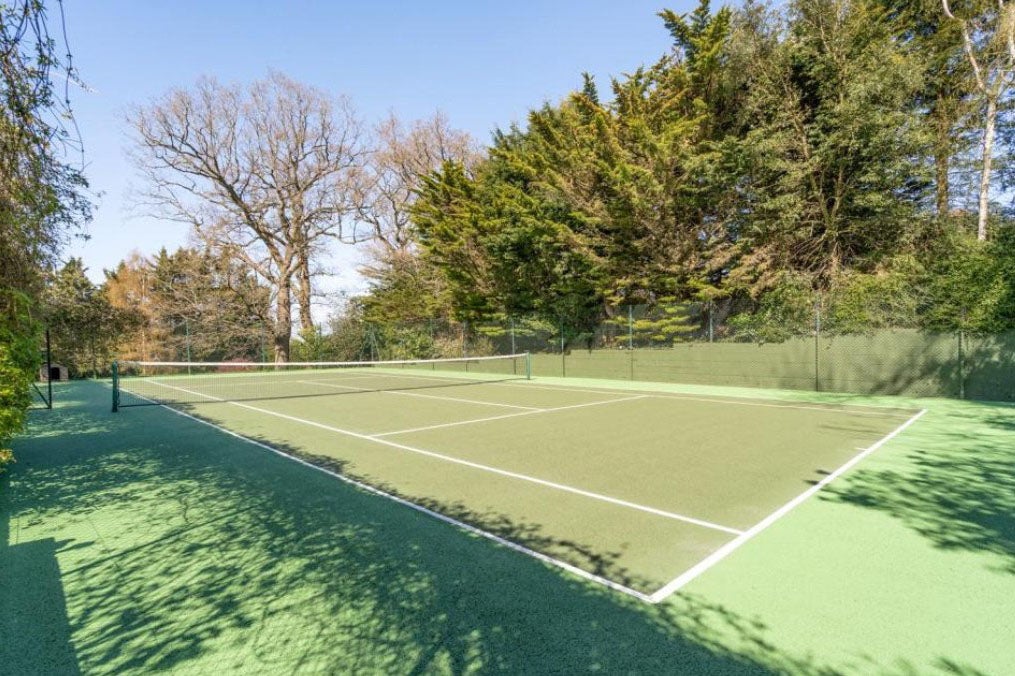 The tennis court at John Meager's former home, Oak Lodge, where Barry Relph suffered a gardening accident
