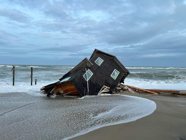 An unoccupied home collapses on the beach in Rodanthe, North Carolina. The storms that have impacted the U.S. have resulted in multiple house collapses in the state