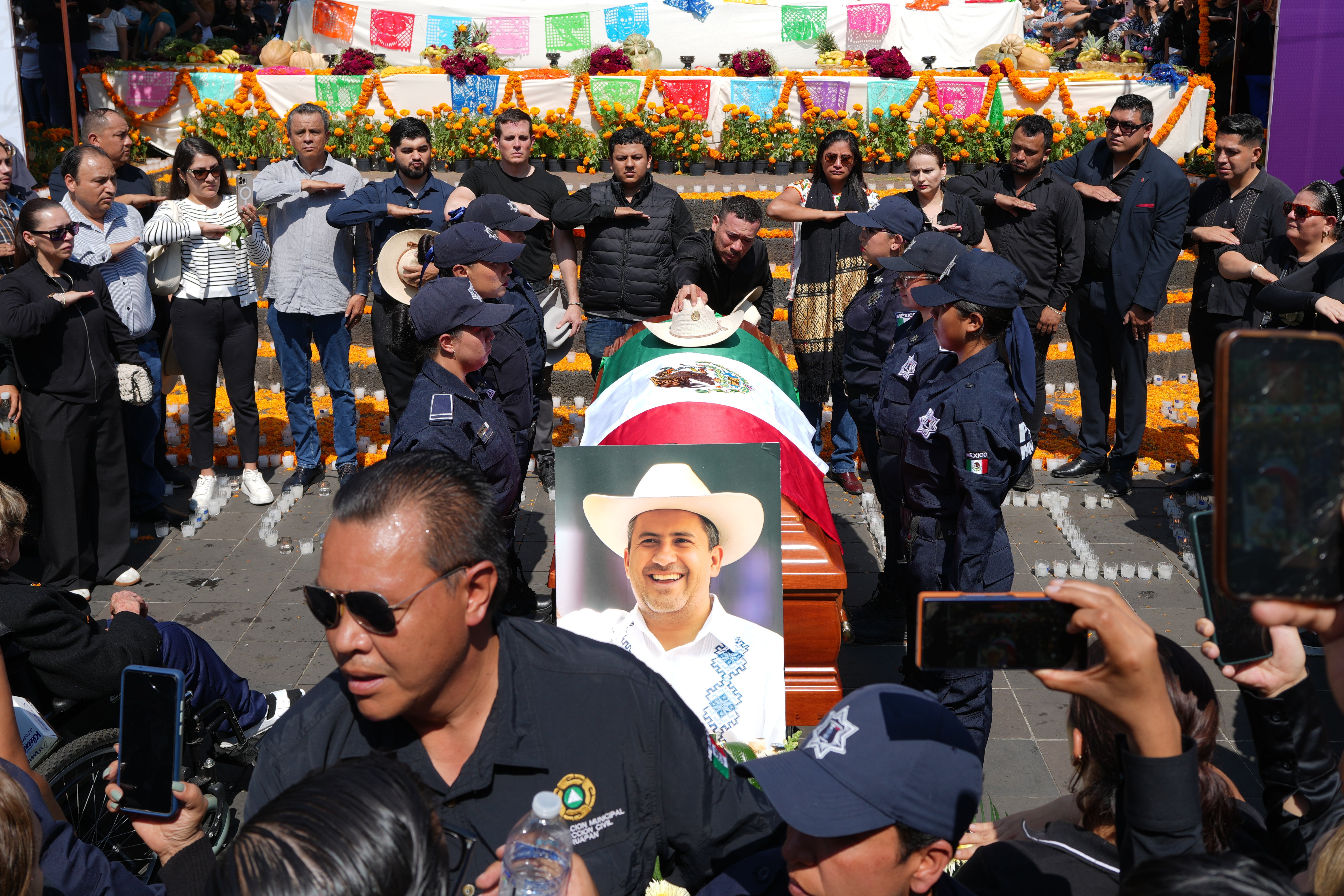 People gather to honor late Mayor Carlos Alberto Manzo Rodríguez, who was shot during Day of the Dead celebrations, in Uruapan, Michoacan state, Mexico, Sunday, Nov. 2, 2025