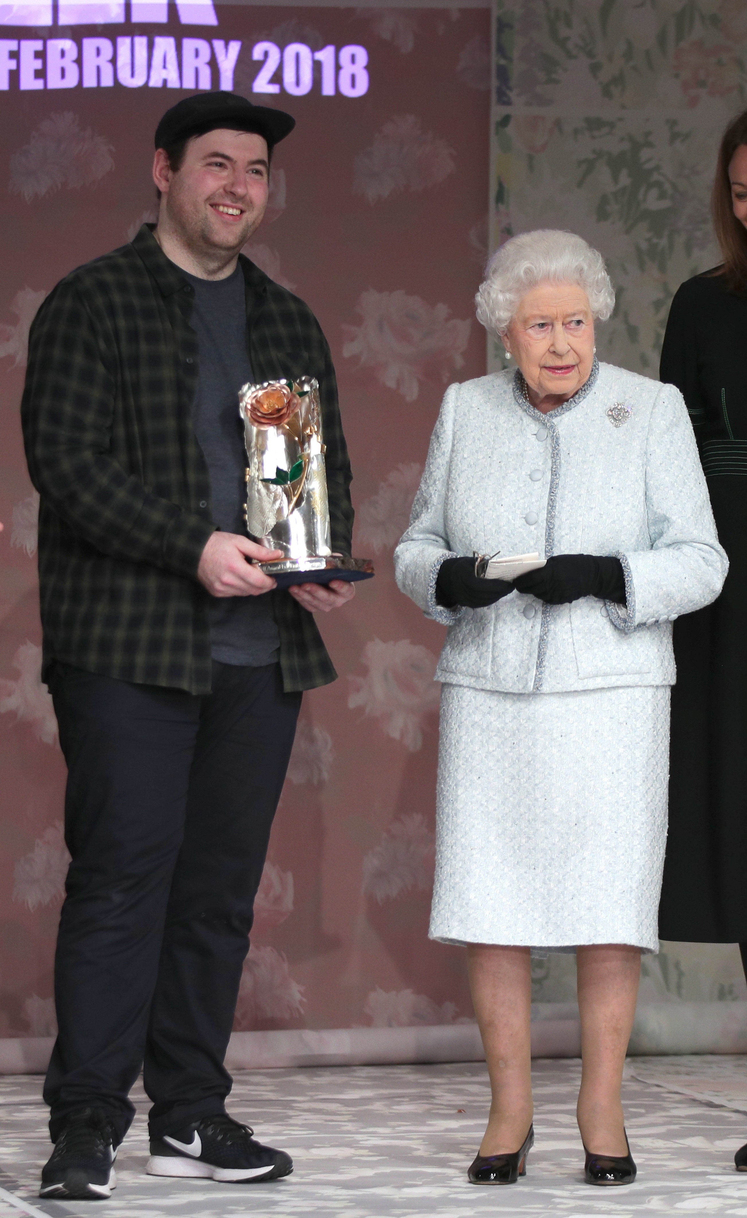 Queen Elizabeth II presents Richard Quinn with the inaugural Queen Elizabeth II Award for British Design