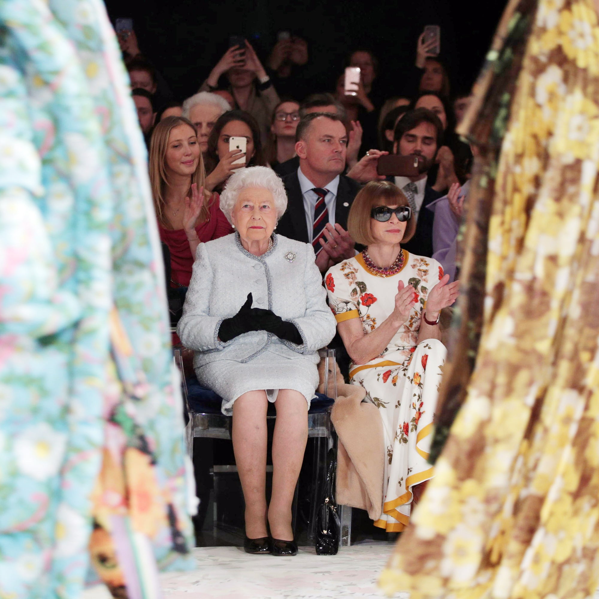 The late Queen Elizabeth II sitting next to Dame Anna Wintour at Richard Quinn’s catwalk show during London Fashion Week in 2018