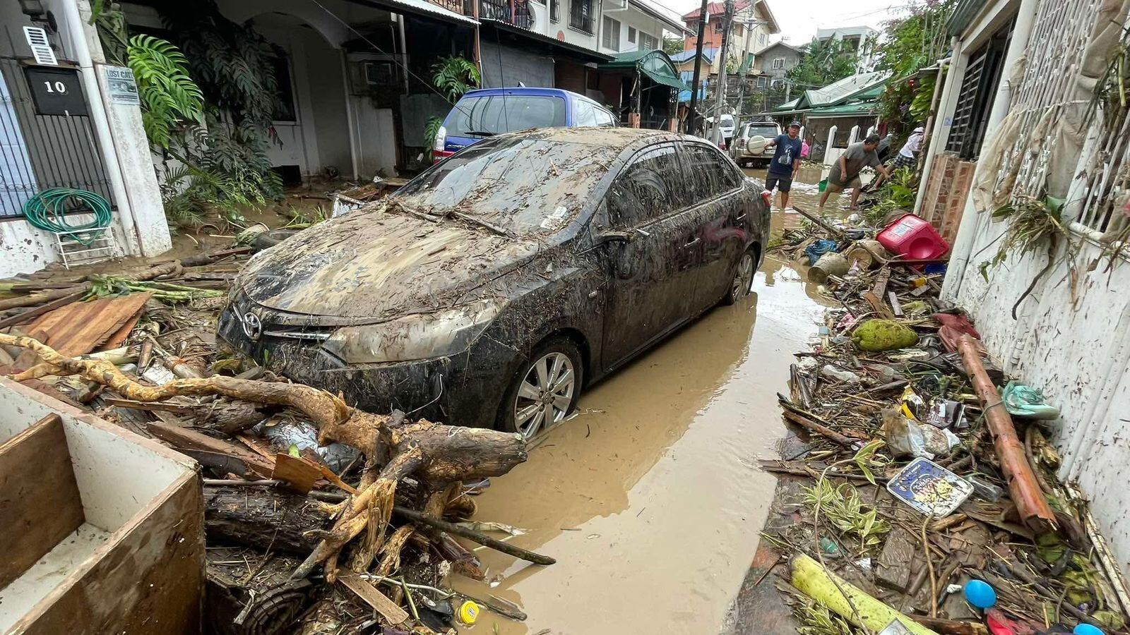 Damaged vehicles in a flooded street