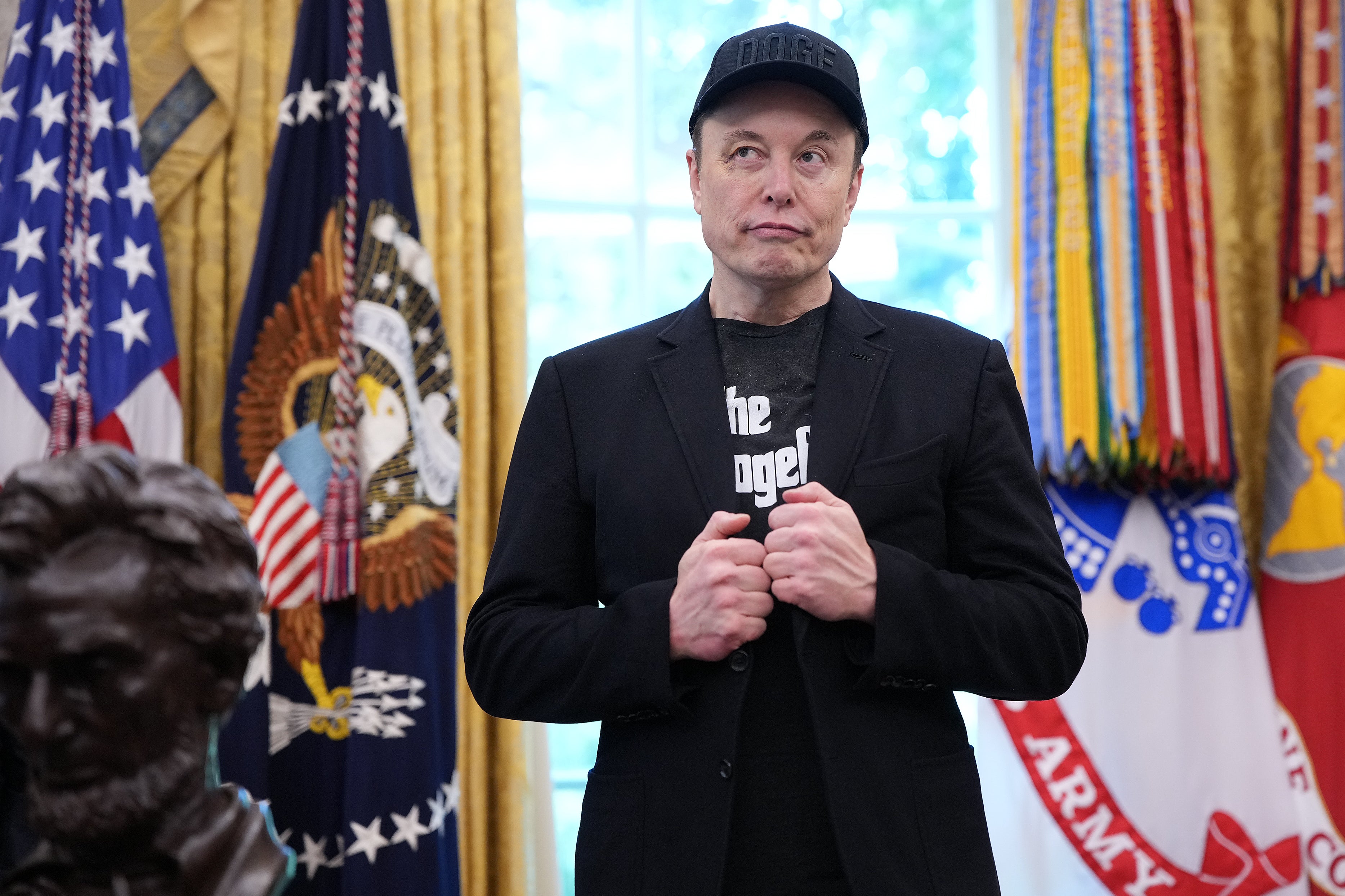 Tesla CEO Elon Musk listens as U.S. President Donald Trump speaks to reporters in the Oval Office of the White House on May 30, 2025 in Washington, DC