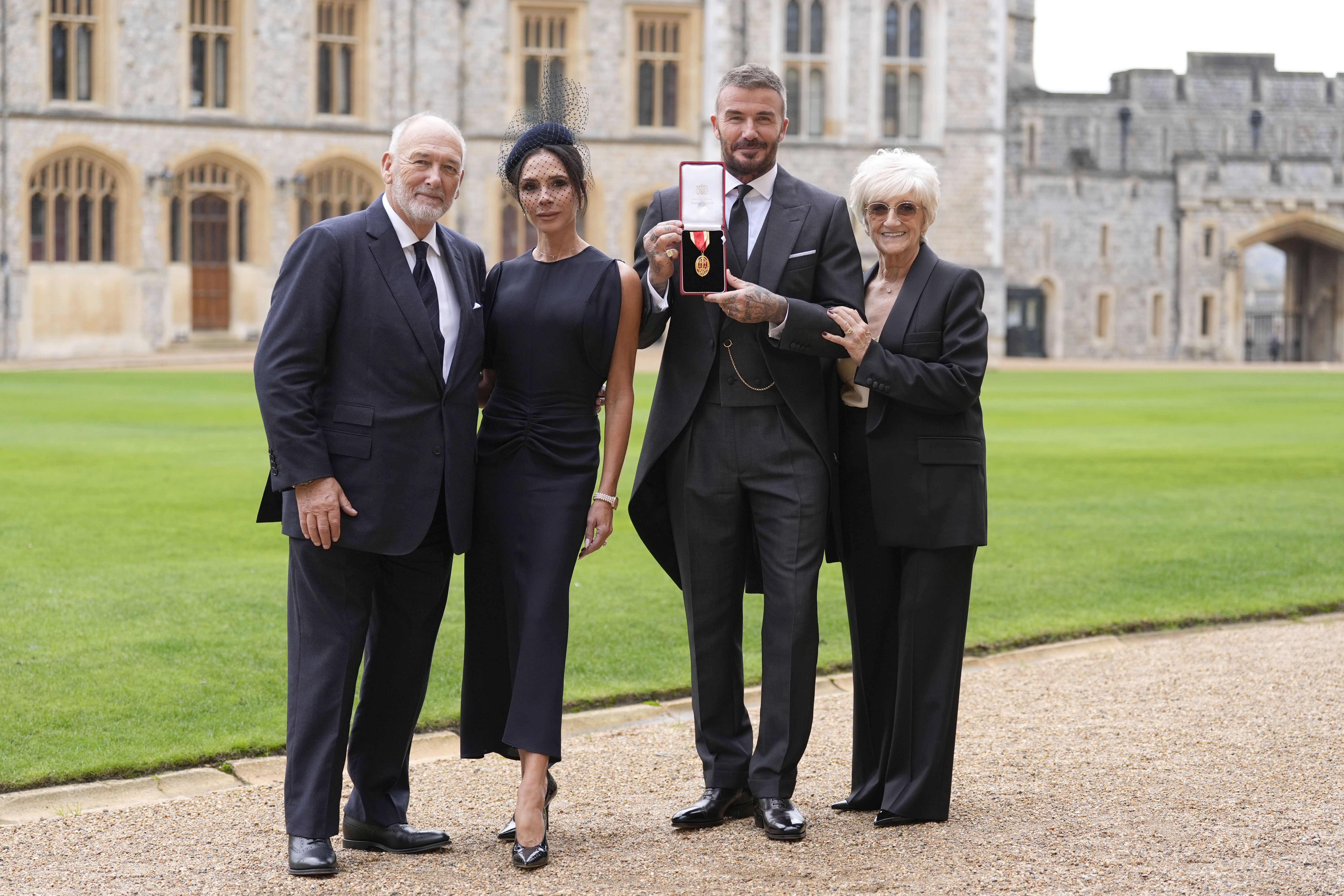 Beckham, with his wife Victoria and parents Ted and Sandra, after he was made a Knight Bachelor