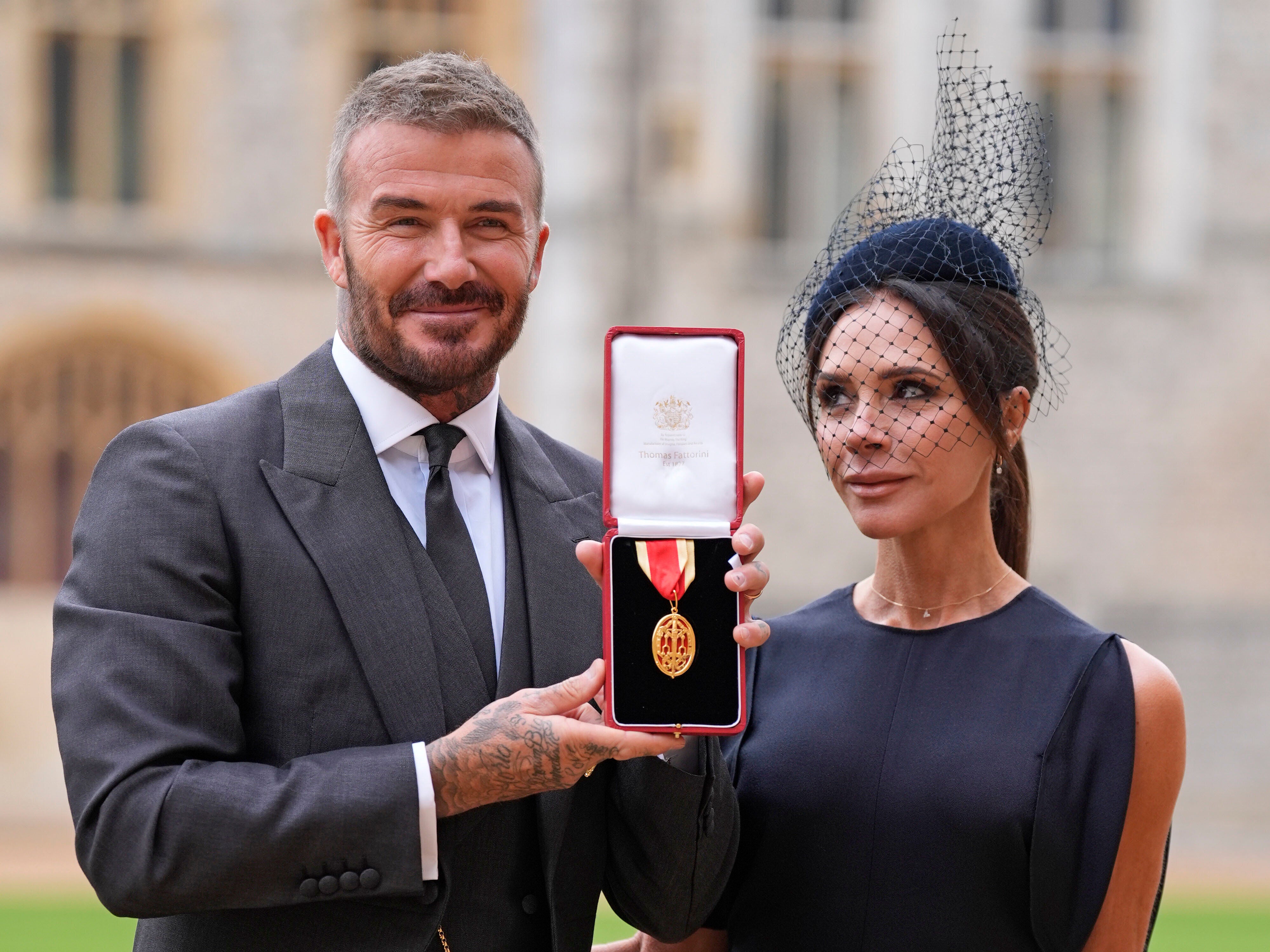 <p>David Beckham receives with his wife Victoria, after recieving his knighthood from the King at Windsor Castle</p>