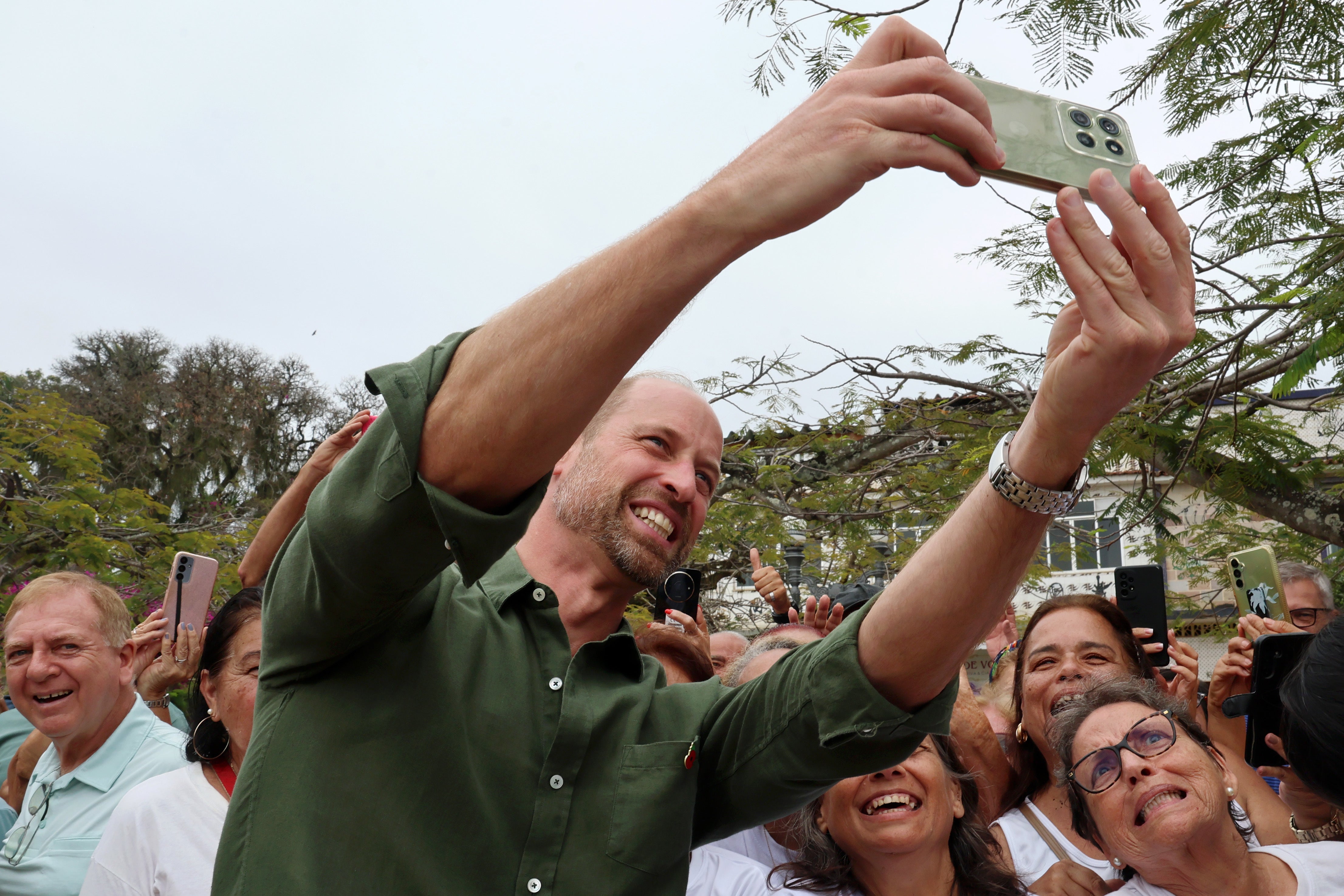 William takes selfies with the crowd on the second day of his tour to Brazil