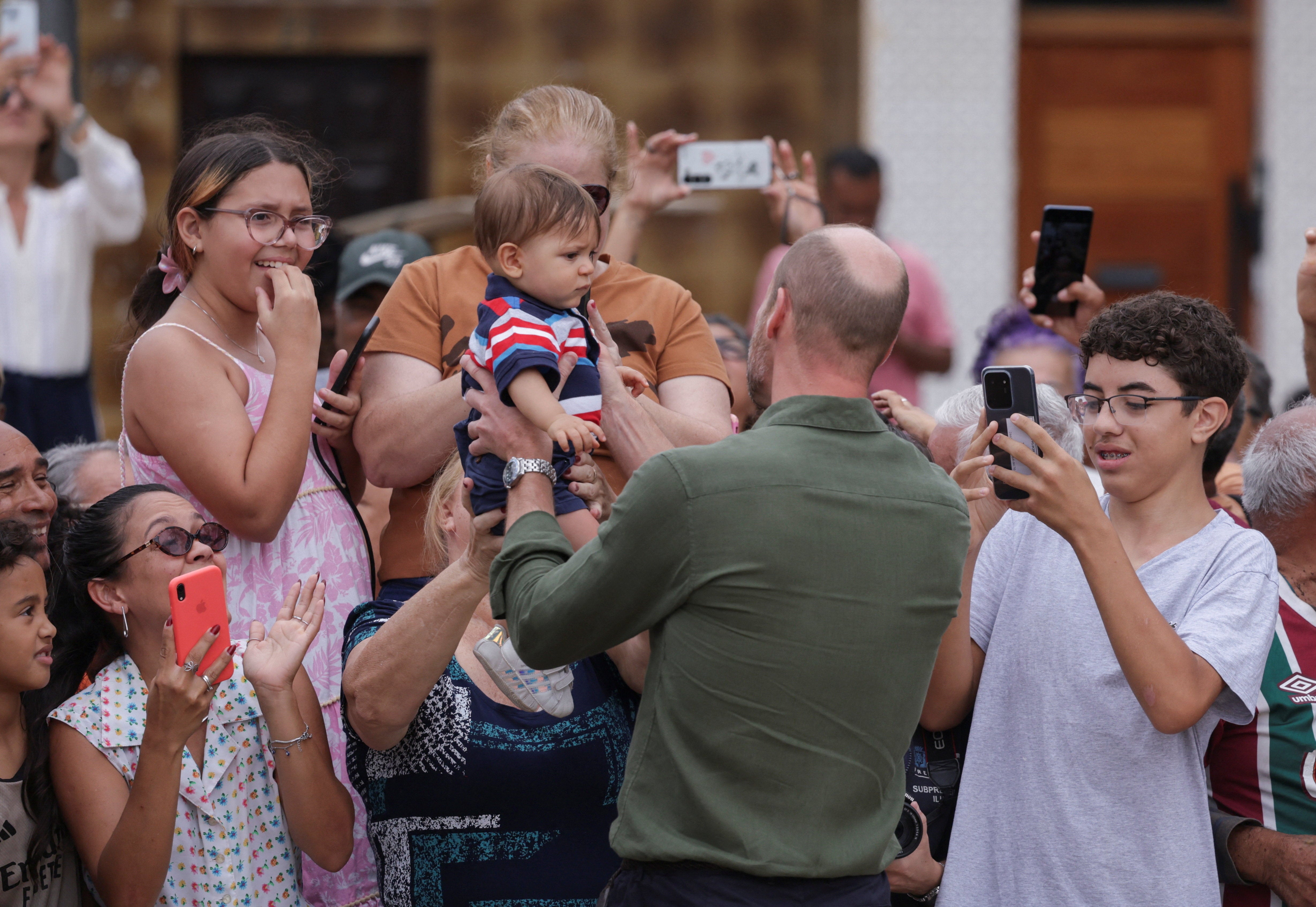 Prince William greets people on Paqueta Island, during an official visit in Rio de Janeiro, Brazil