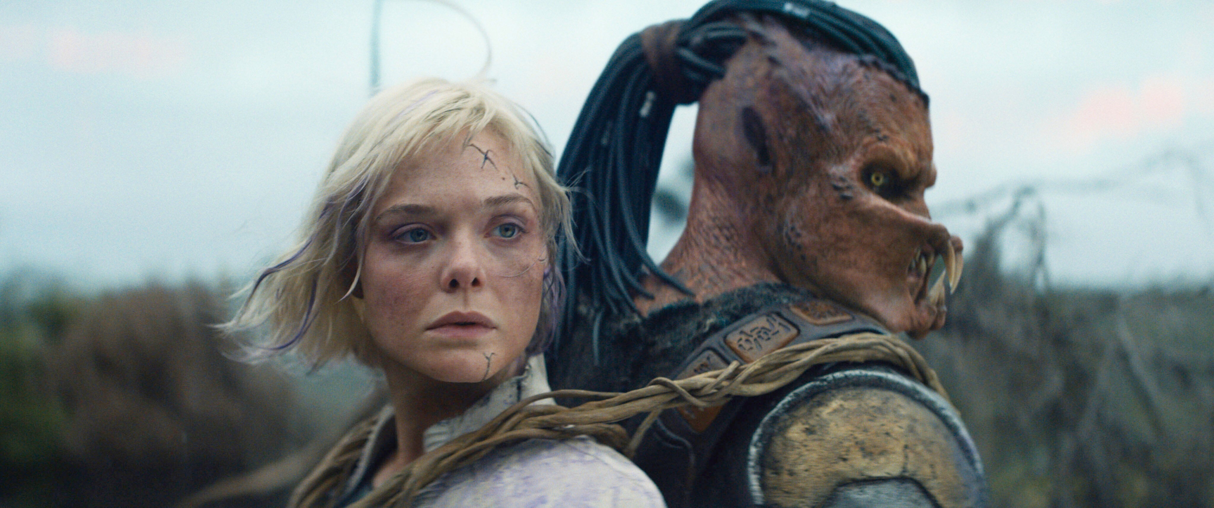 Elle Fanning and Dimitrius Schuster-Koloamatangi in Predator: Badlands