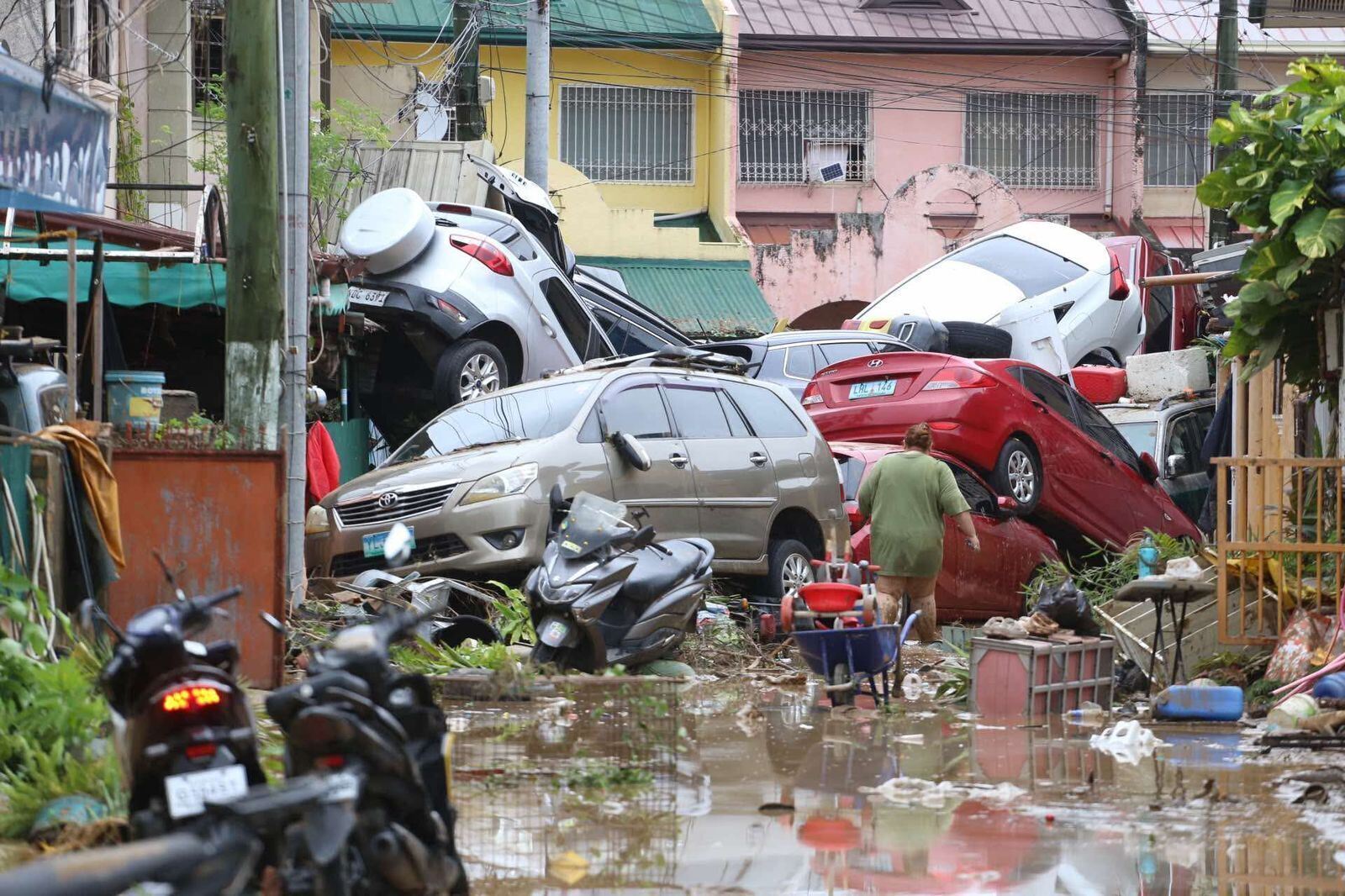 Vehicles lie piled up after Kalmaegi hit Cebu city