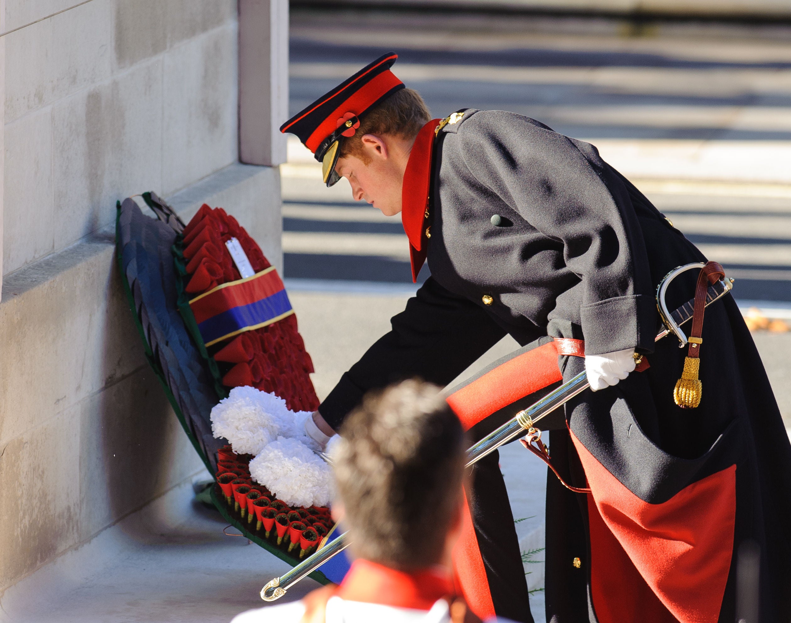 Harry lays a wreath at the Cenotaph memorial in Whitehall on Remembrance Sunday in 2013 A)