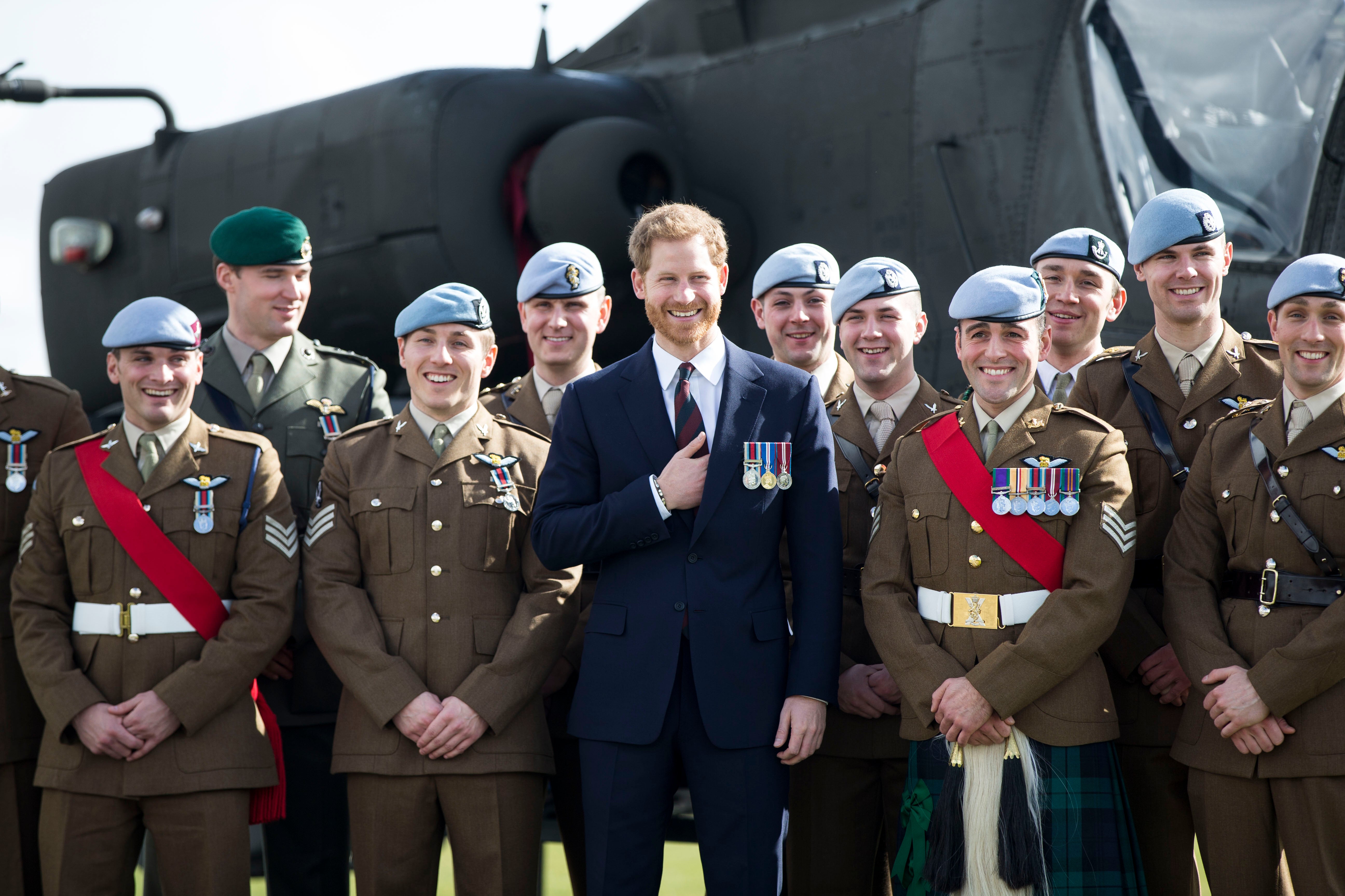 Harry in front of an Apache Helicopter at the Army Aviation Centre after presenting graduates with their Wings in 2018 (Heathcliff O’Malley/Daily Telegraph/PA)