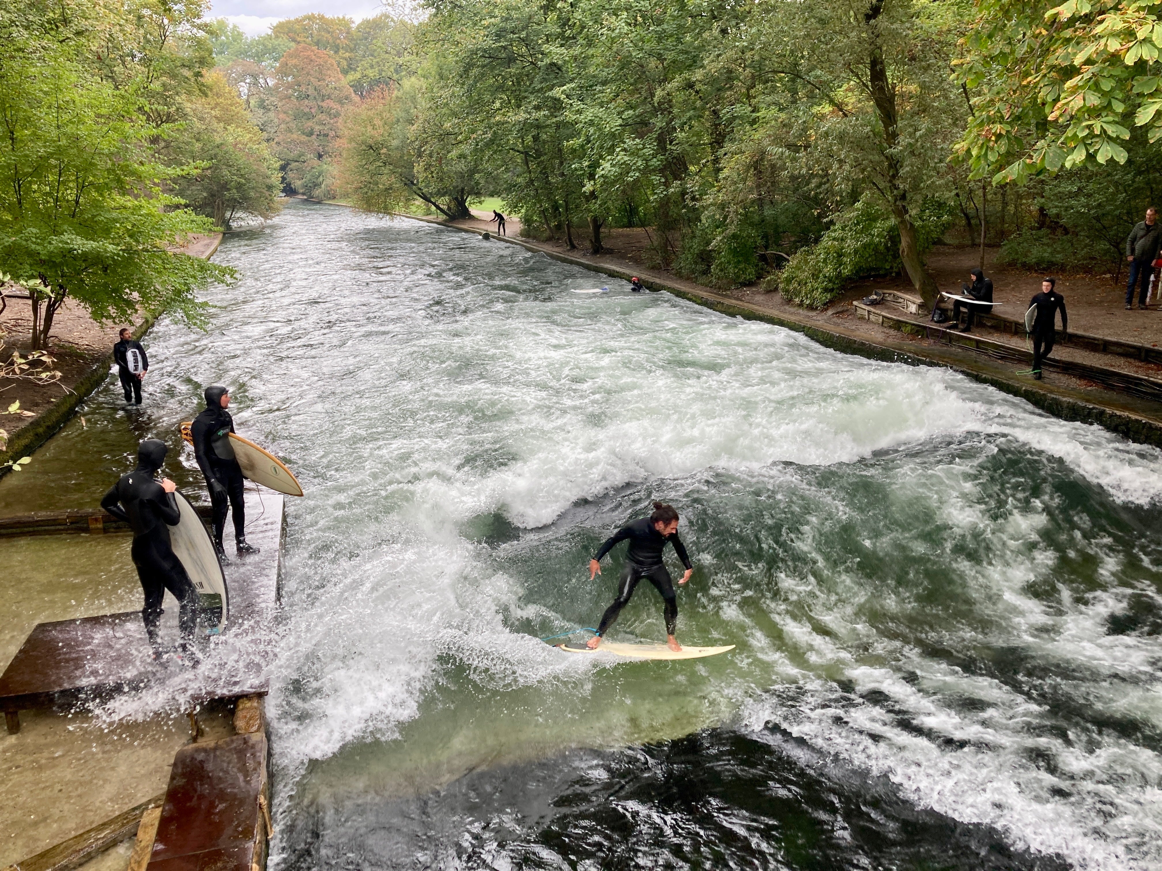 Surfers tackle the Isar River's man-made Eisbach (icy creek) wave