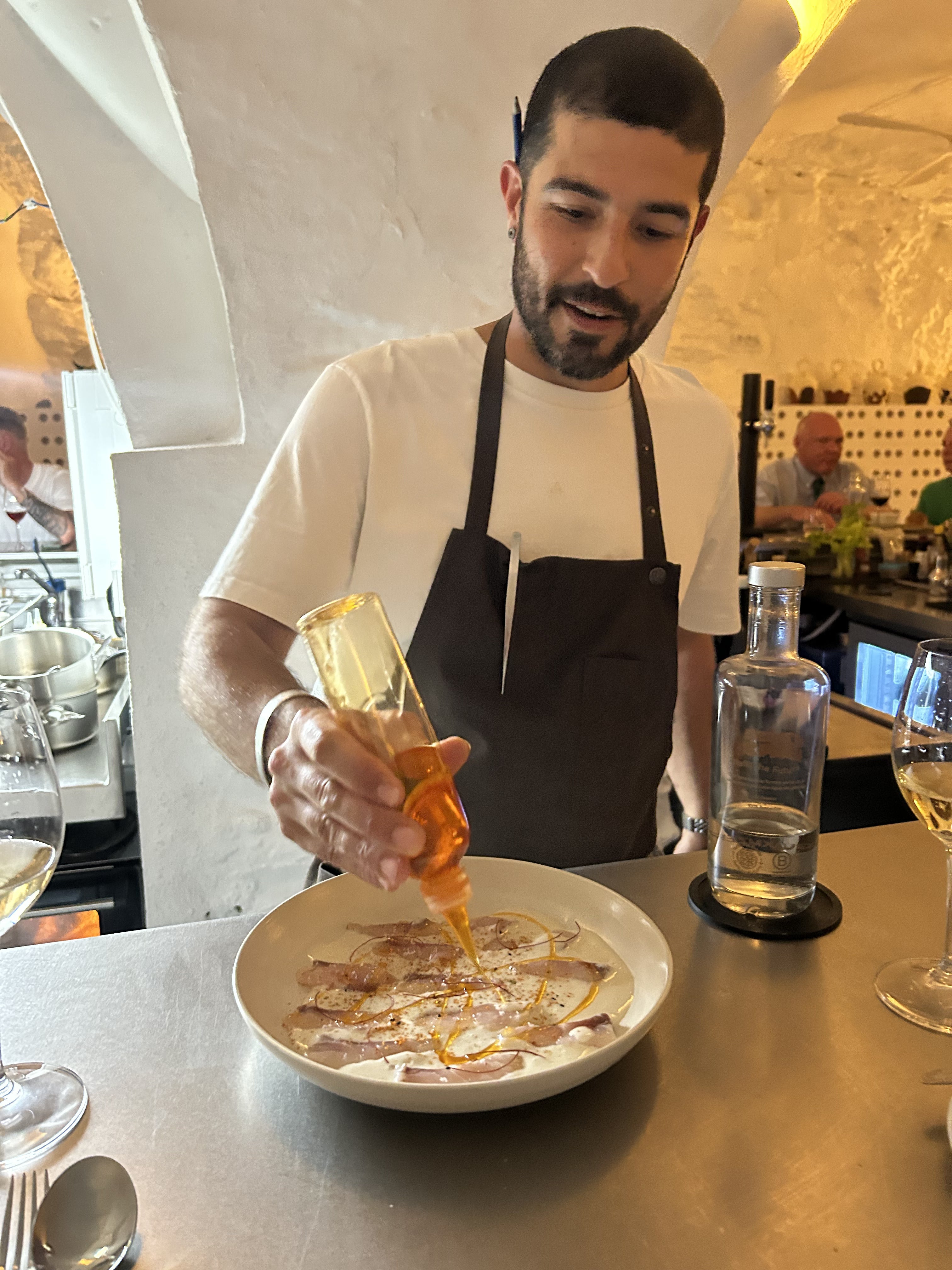 Monty Aguiló cooking sea bass dish at Oli Bar