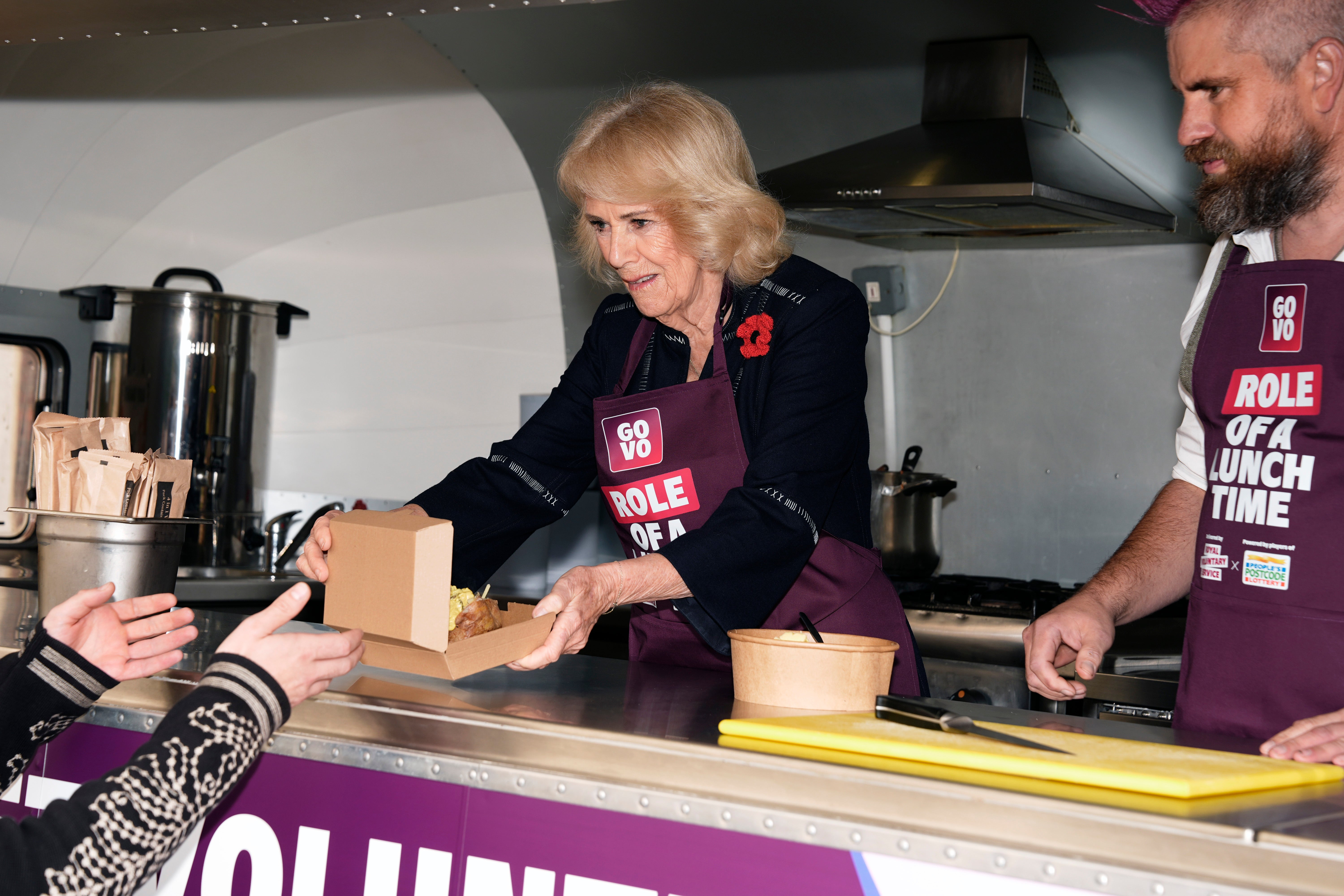 <p>Queen Camilla with TikTok star Spudman, inside 'The Role of a Lunchtime' street food truck as they discuss volunteering roles available through the charity Royal Voluntary Service's new digital volunteering platform, GoVo</p>