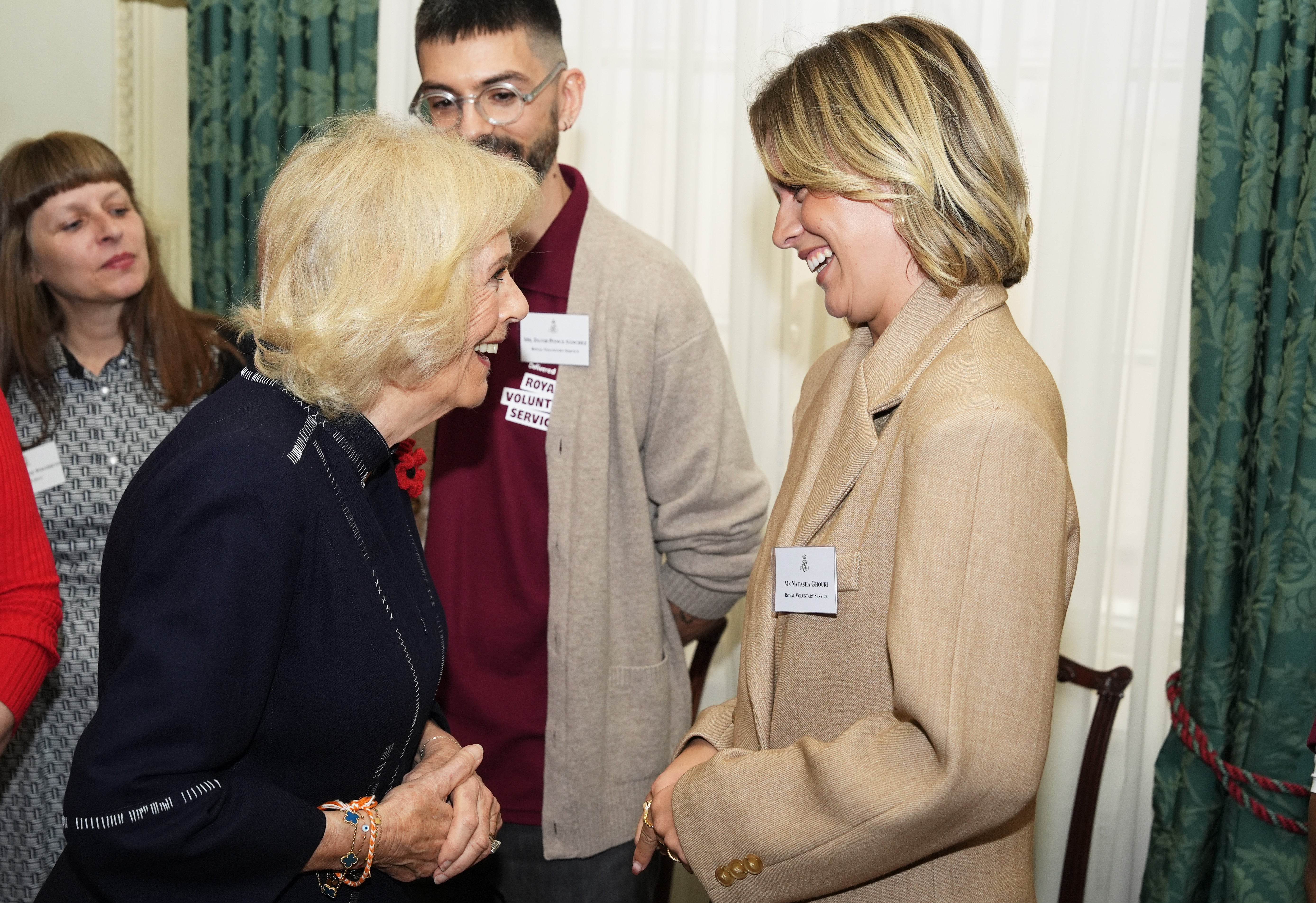 Queen Camilla speaks to Natasha Ghouri at Clarence House