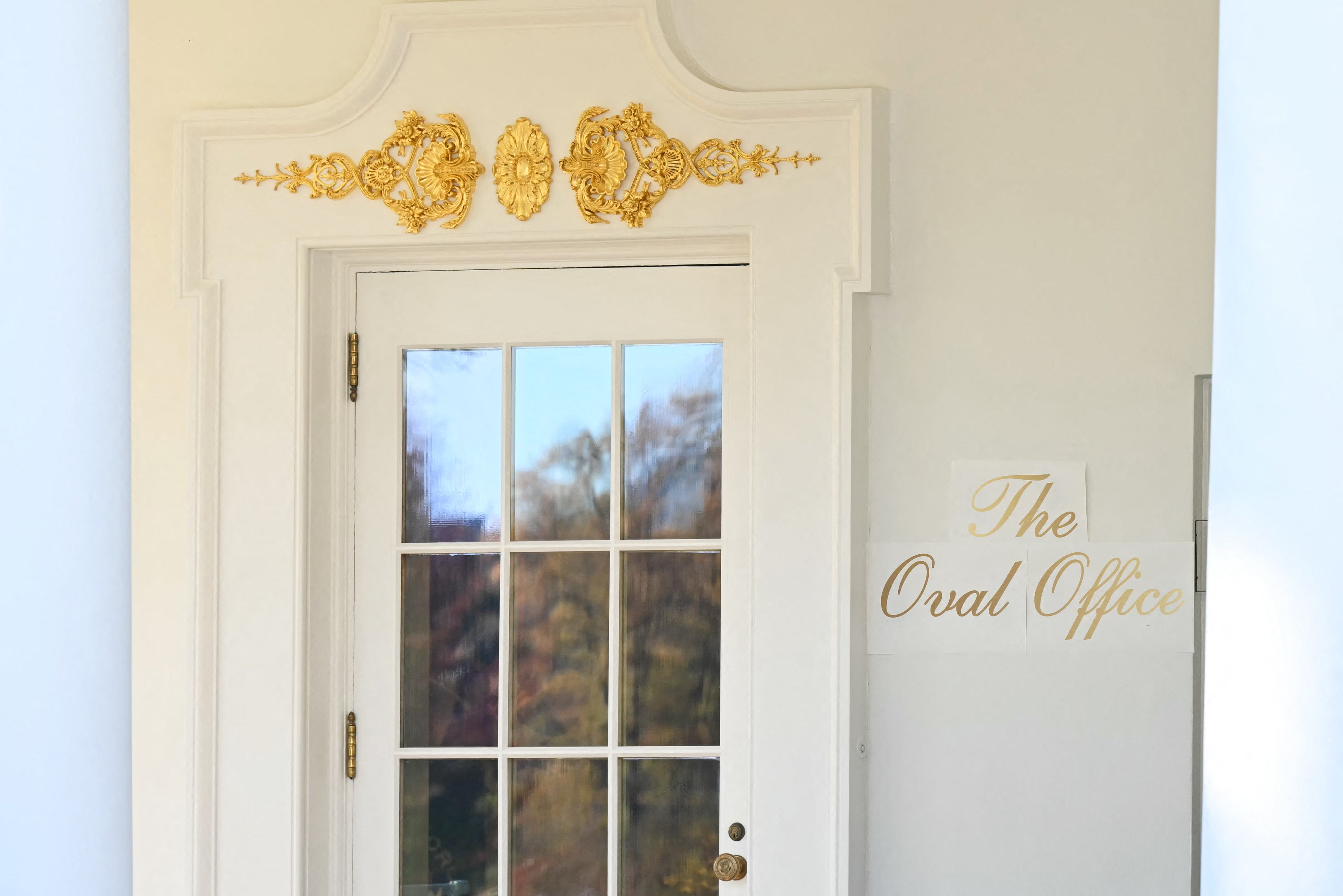 As Trump prepared to depart the White House en route to a speech in Miami, Florida, reporters waiting for him noticed an addition to the exterior of the building — a sign in gilded script indicating the entrance to the Oval Office as seen from the White House Rose Garden.