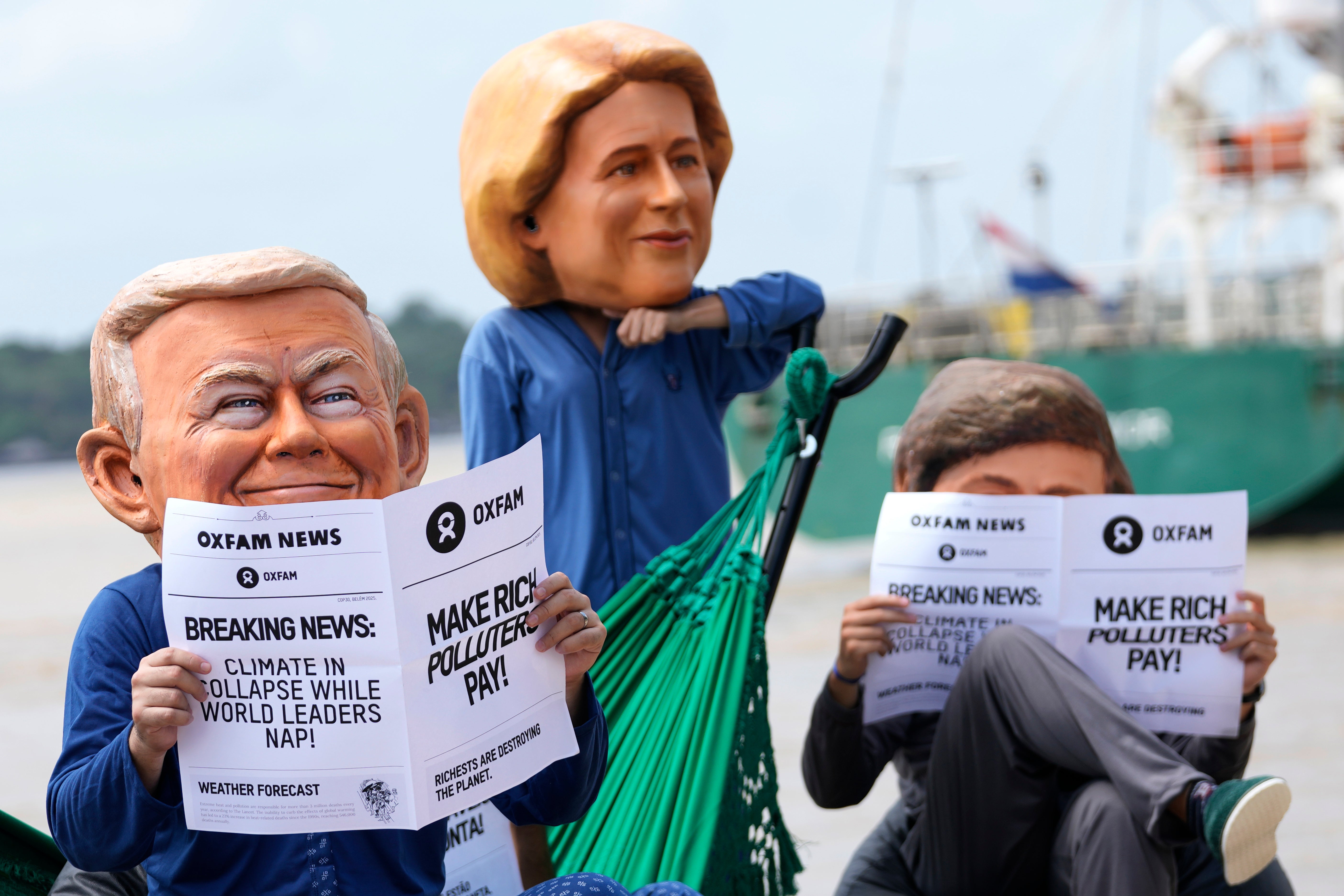 Oxfam activists wear puppet heads in the likeness of US president Donald Trump, left, President of the European Commission Ursula von der Leyen, center, and president of Argentina Javier Milei as they protest ahead of the Cop30 UN Climate Summit in Belem, Para state, Brazil