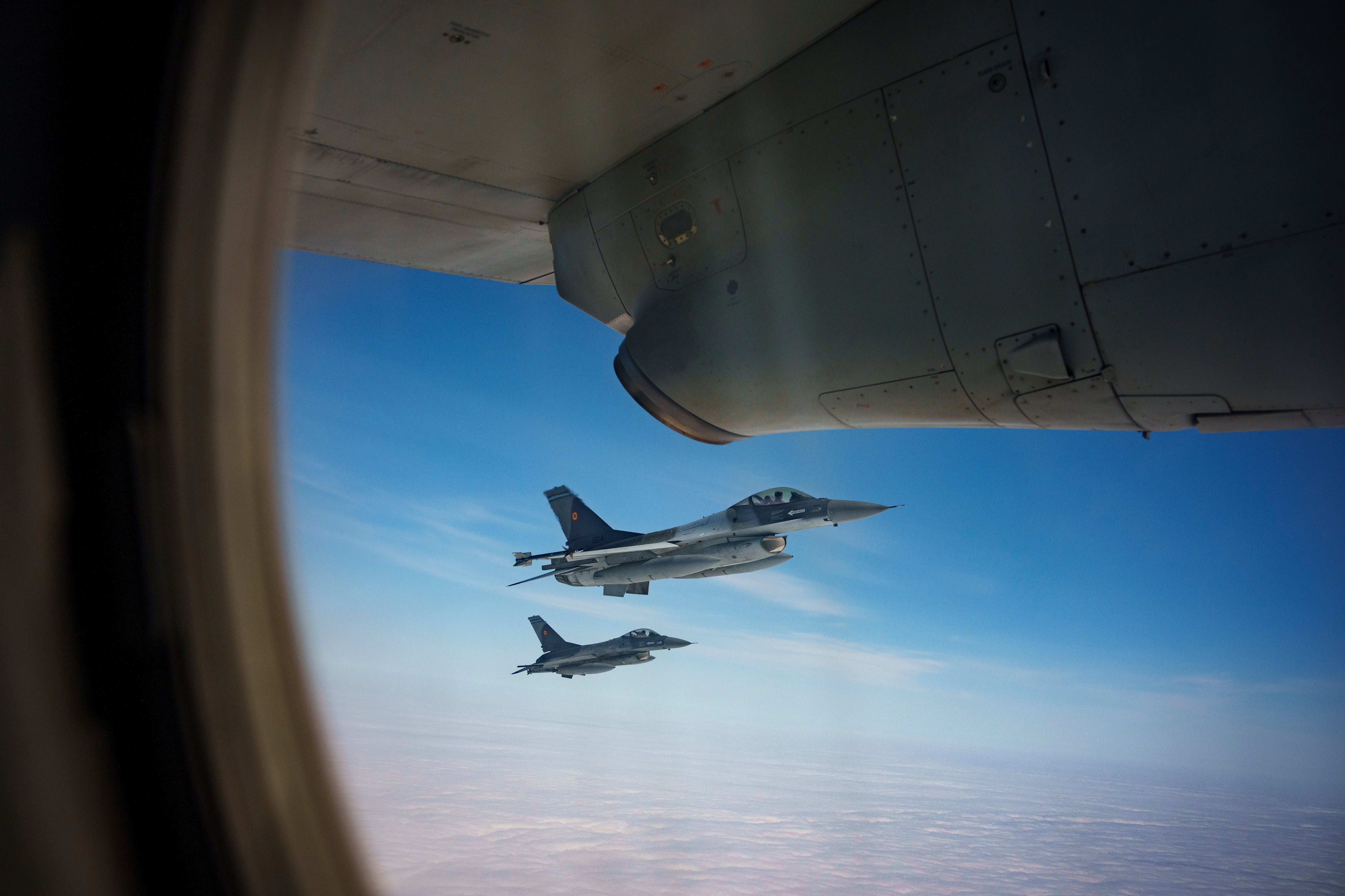 FILE - Romanian Air Force F-16 military fighter jets escort a C-27J Spartan aircraft during a NATO Air Policing exercise above eastern Romania, on 6 March 2024