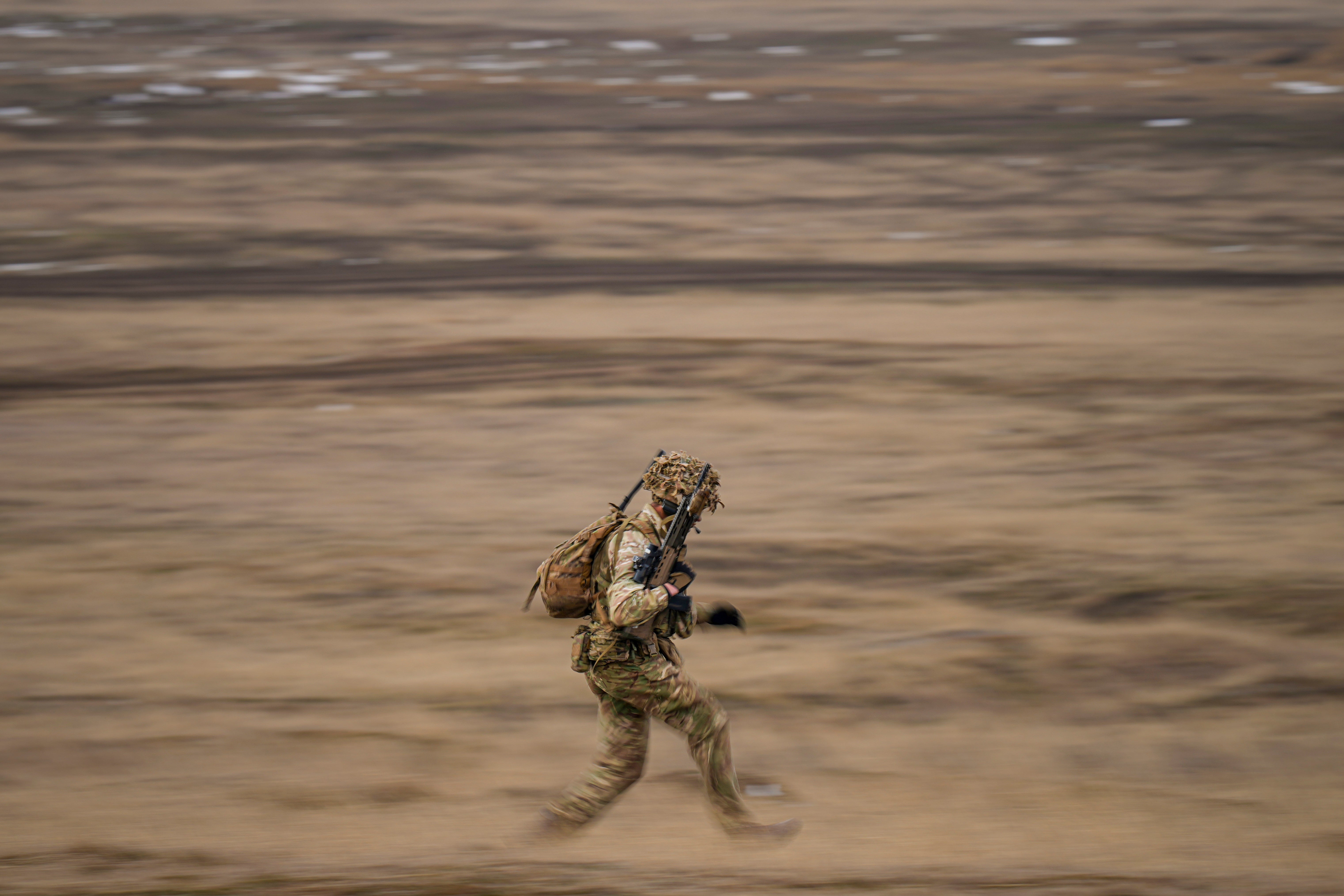 A British serviceman runs during the Steadfast Dart 2025 exercise, the largest NATO operation planned this year, at a training range in Smardan, eastern Romania, on Feb. 19, 2025. (AP Photo/Vadim Ghirda, File)