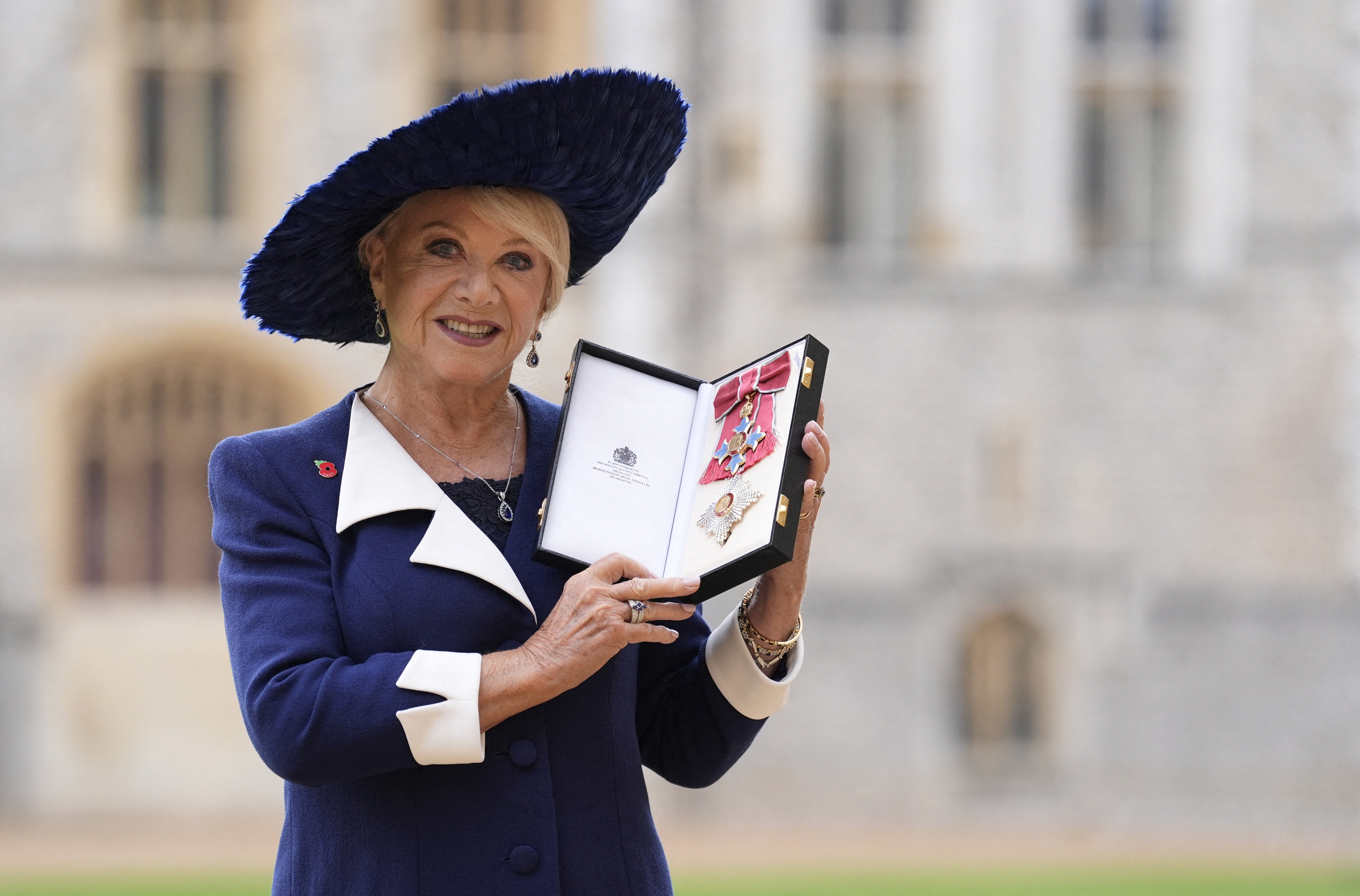 Dame Elaine Paige stands after she was made a Dame Commander of the British Empire at Windsor Castle.