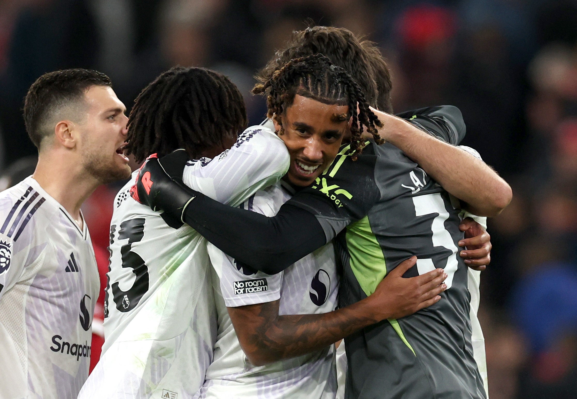 Yoro celebrates with teammates after United’s win at Anfield