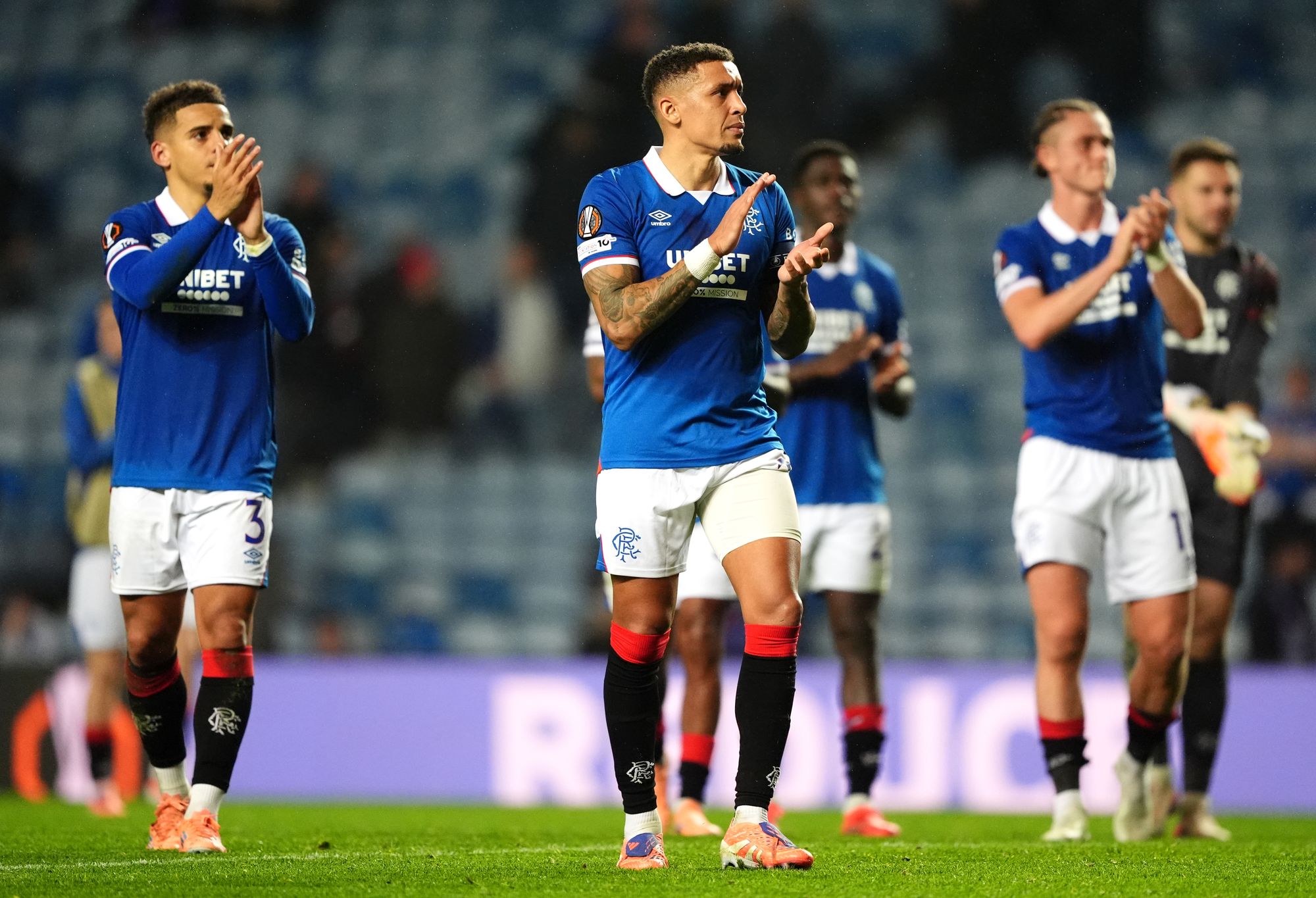 Rangers players applaud the fans after defeat to Roma